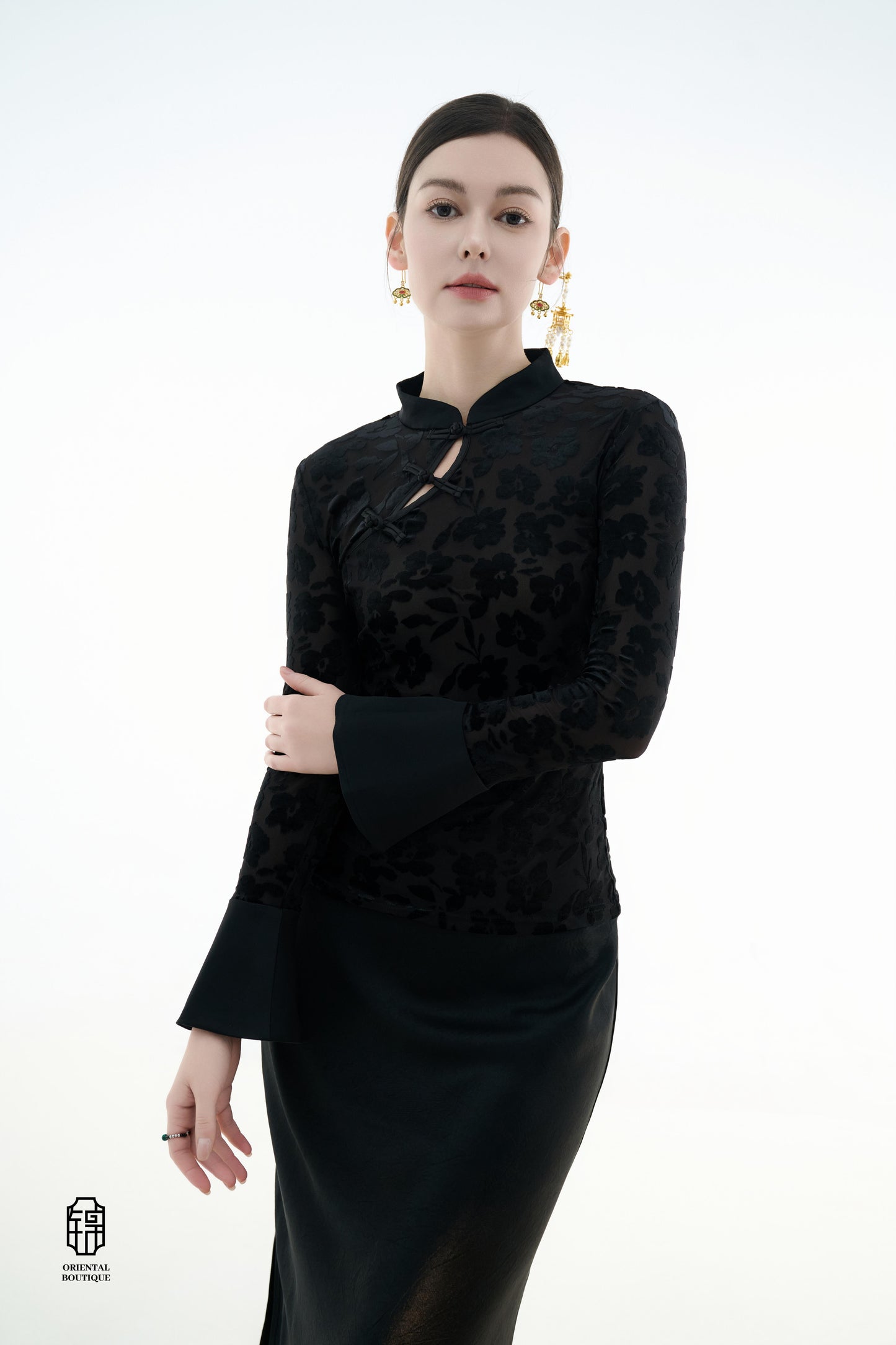 Ink Floral Silhouette Blouse,The Ink Floral Silhouette Blouse is an elegant top that combines traditional Eastern aesthetics with modern fashion elements, featuring a deep black base color. The fabric showcases a subtle floral jacquard pattern that shimme