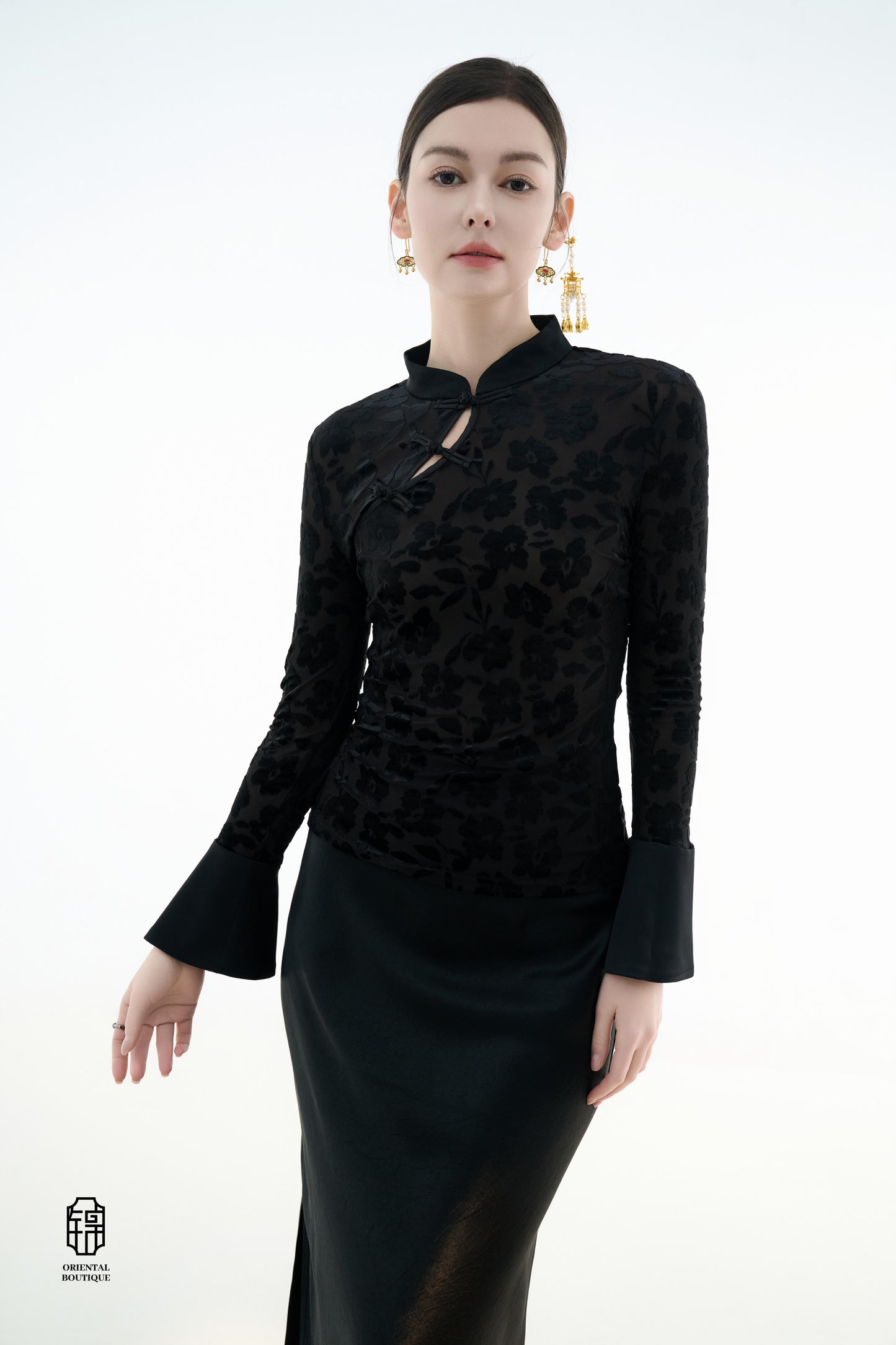 Ink Floral Silhouette Blouse,The Ink Floral Silhouette Blouse is an elegant top that combines traditional Eastern aesthetics with modern fashion elements, featuring a deep black base color. The fabric showcases a subtle floral jacquard pattern that shimme