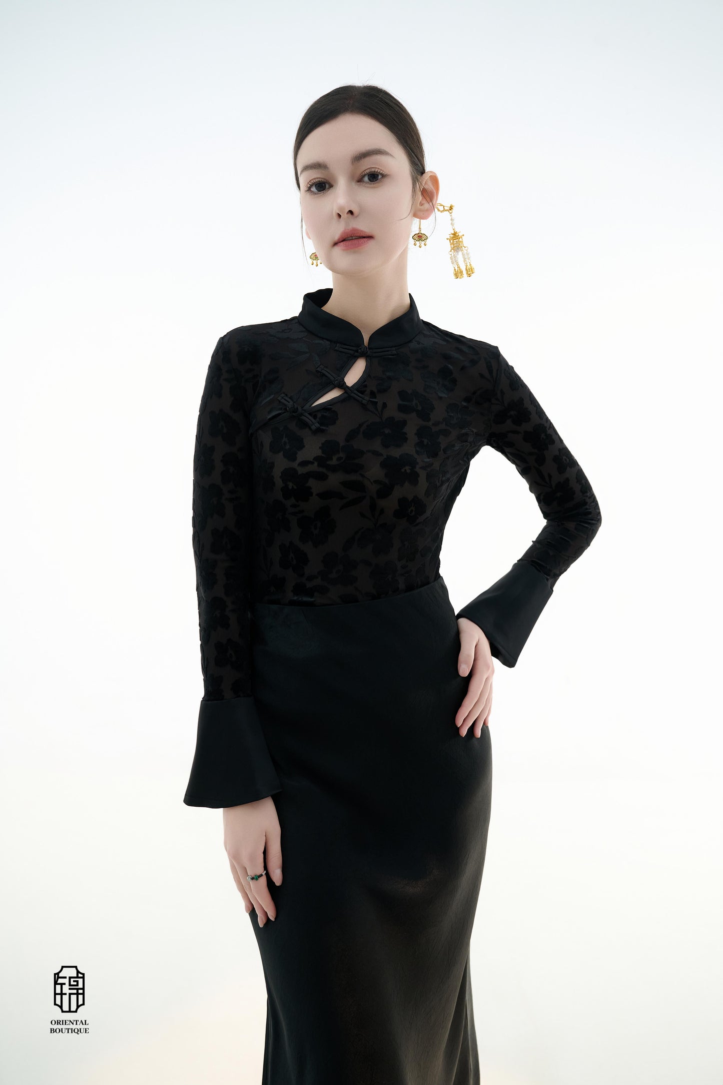Ink Floral Silhouette Blouse,The Ink Floral Silhouette Blouse is an elegant top that combines traditional Eastern aesthetics with modern fashion elements, featuring a deep black base color. The fabric showcases a subtle floral jacquard pattern that shimme