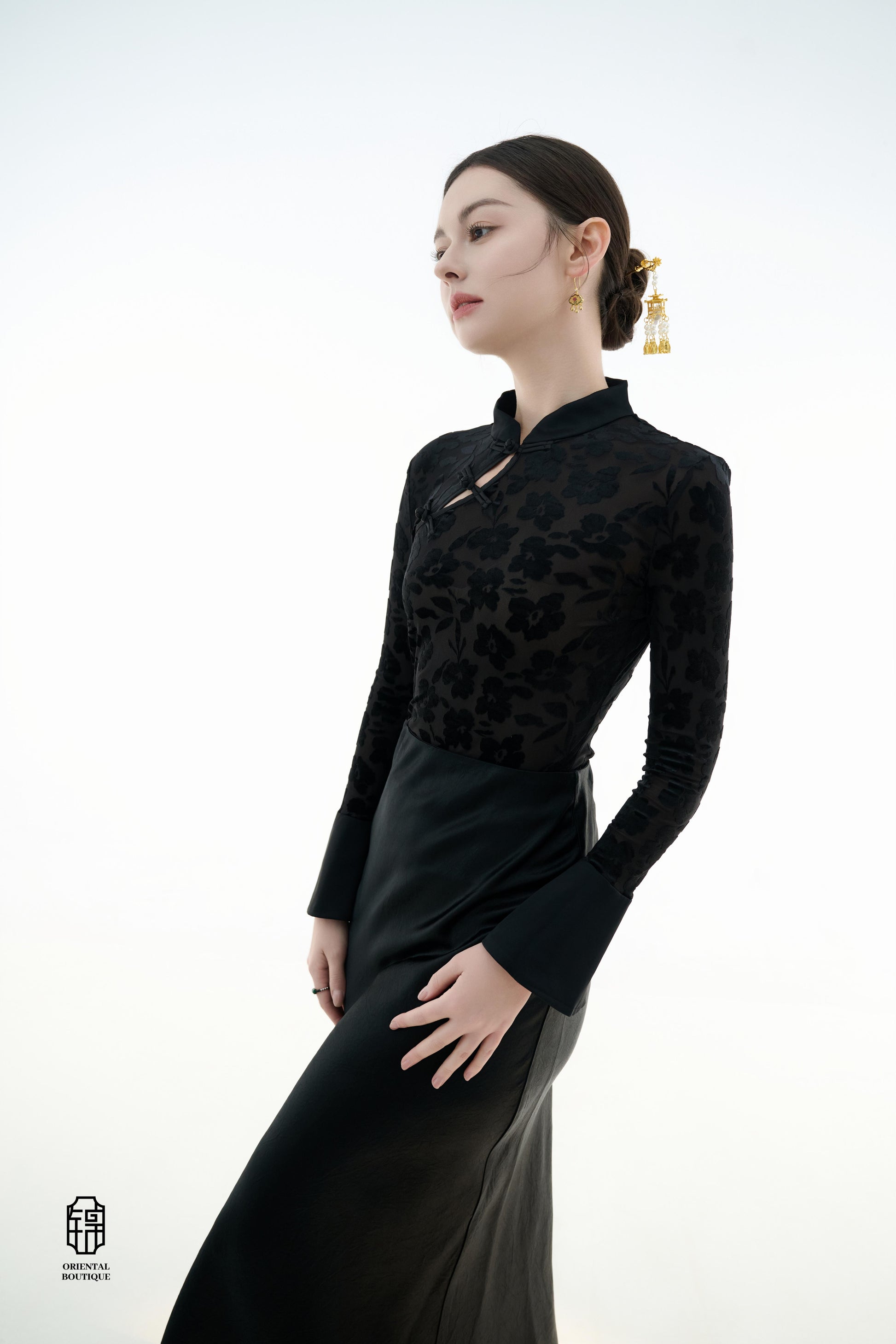 Ink Floral Silhouette Blouse,The Ink Floral Silhouette Blouse is an elegant top that combines traditional Eastern aesthetics with modern fashion elements, featuring a deep black base color. The fabric showcases a subtle floral jacquard pattern that shimme