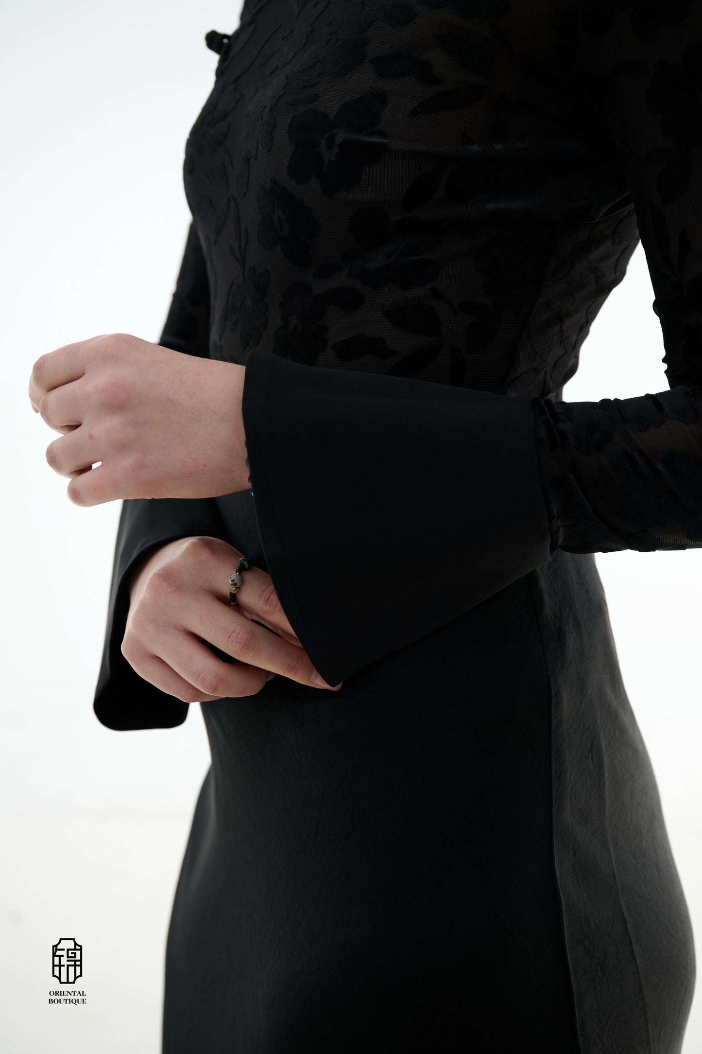 Ink Floral Silhouette Blouse,The Ink Floral Silhouette Blouse is an elegant top that combines traditional Eastern aesthetics with modern fashion elements, featuring a deep black base color. The fabric showcases a subtle floral jacquard pattern that shimme