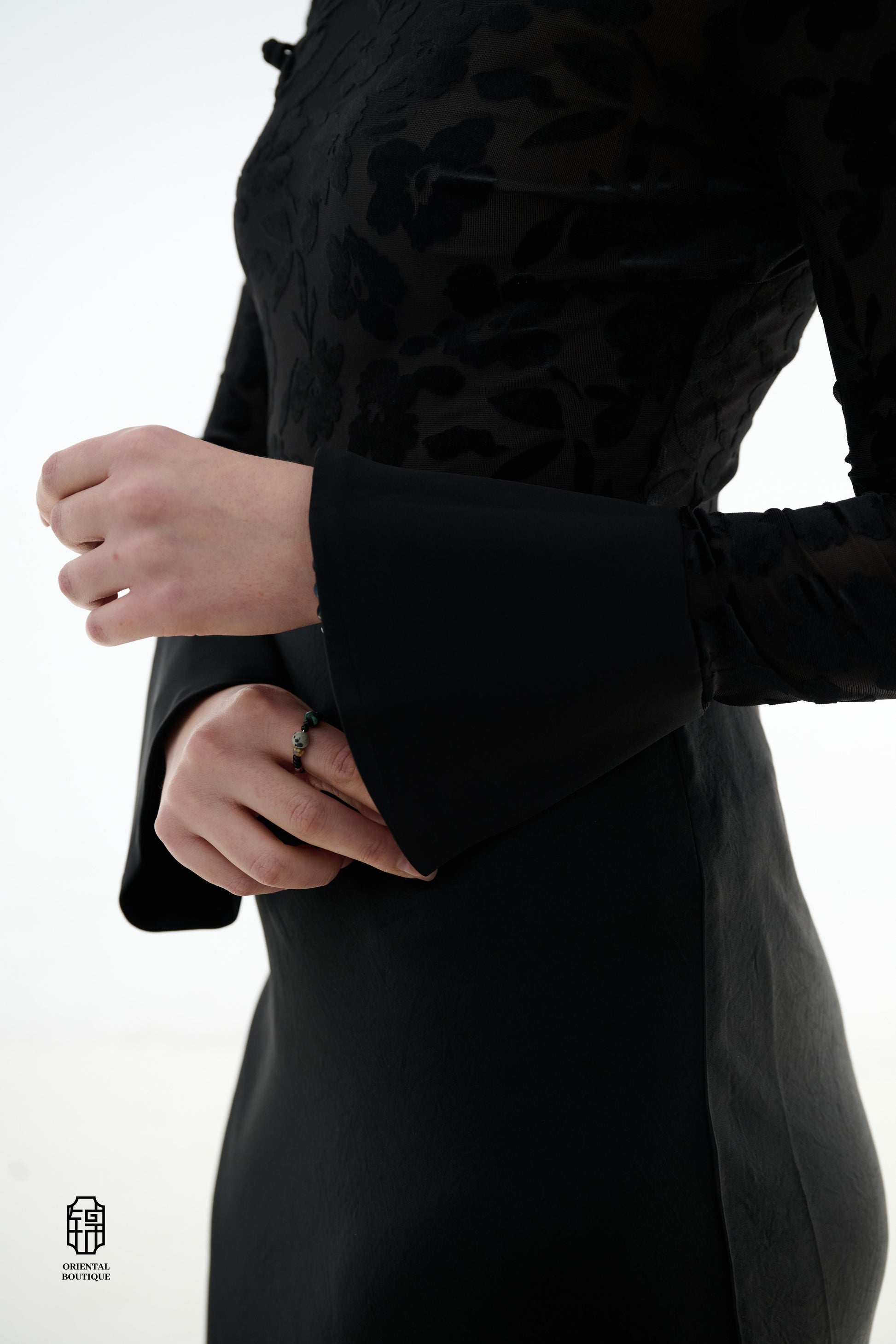 Ink Floral Silhouette Blouse,The Ink Floral Silhouette Blouse is an elegant top that combines traditional Eastern aesthetics with modern fashion elements, featuring a deep black base color. The fabric showcases a subtle floral jacquard pattern that shimme