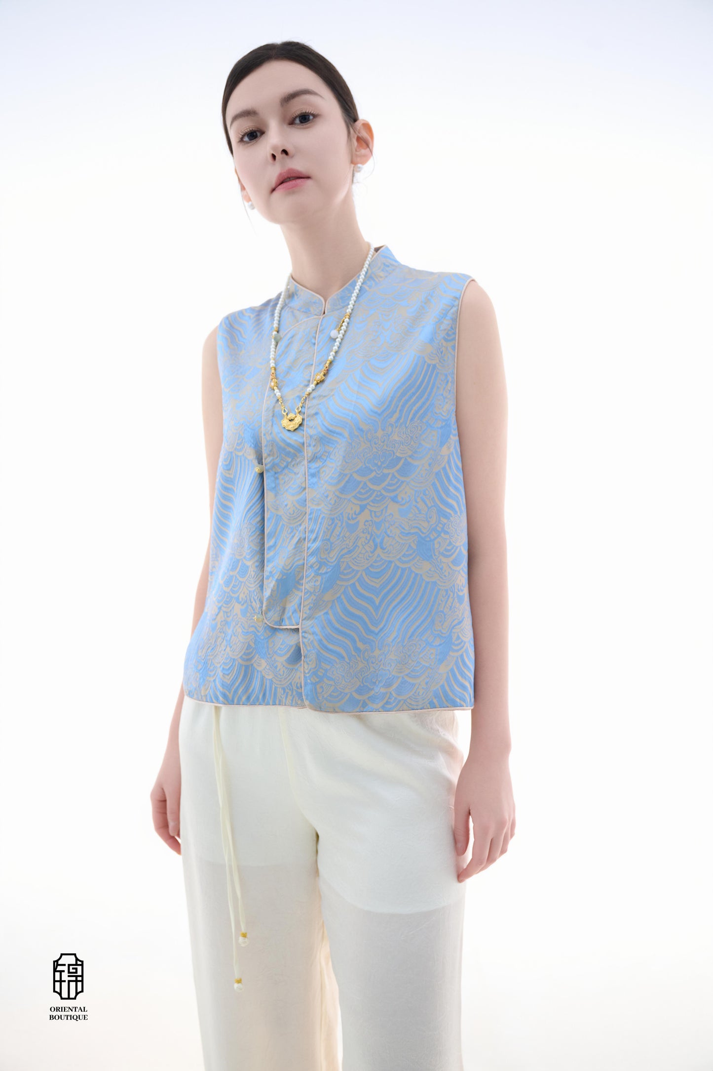 Blue Ocean Cloud Sleeveless Top,The Blue Ocean Cloud Sleeveless Top is crafted from a delicate light blue silk fabric, featuring intricate patterns of clouds and ocean waves, embodying the elegance and unique aesthetics of Eastern design. The sleeveless c