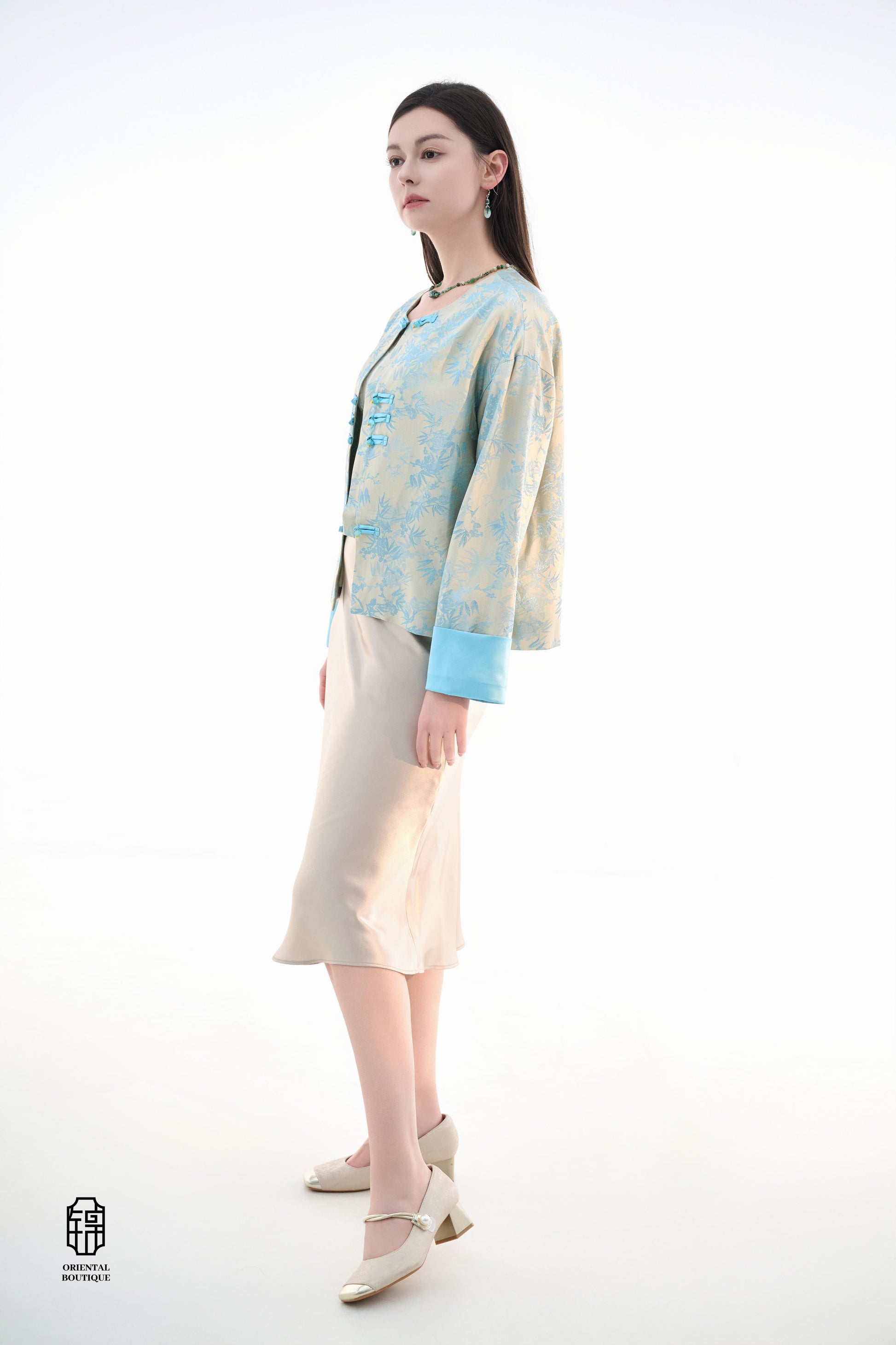 Bamboo Shadow Satin Long-Sleeve Top with Blue Knots,This Bamboo Shadow Satin Long-Sleeve Top features a graceful combination of light blue and beige with a subtle bamboo print. The design is accentuated by traditional Chinese blue knotted buttons and matc