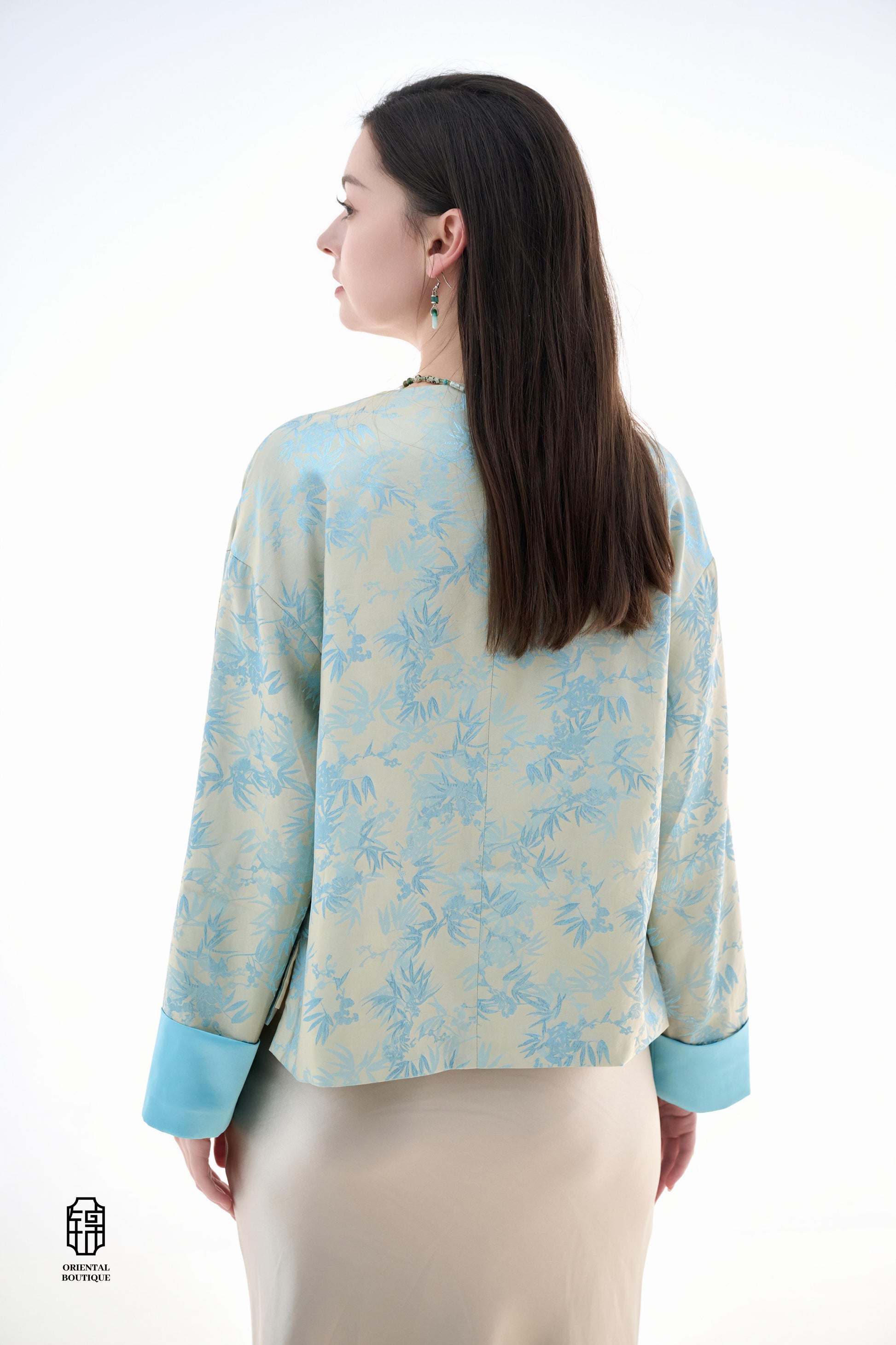 Bamboo Shadow Satin Long-Sleeve Top with Blue Knots,This Bamboo Shadow Satin Long-Sleeve Top features a graceful combination of light blue and beige with a subtle bamboo print. The design is accentuated by traditional Chinese blue knotted buttons and matc