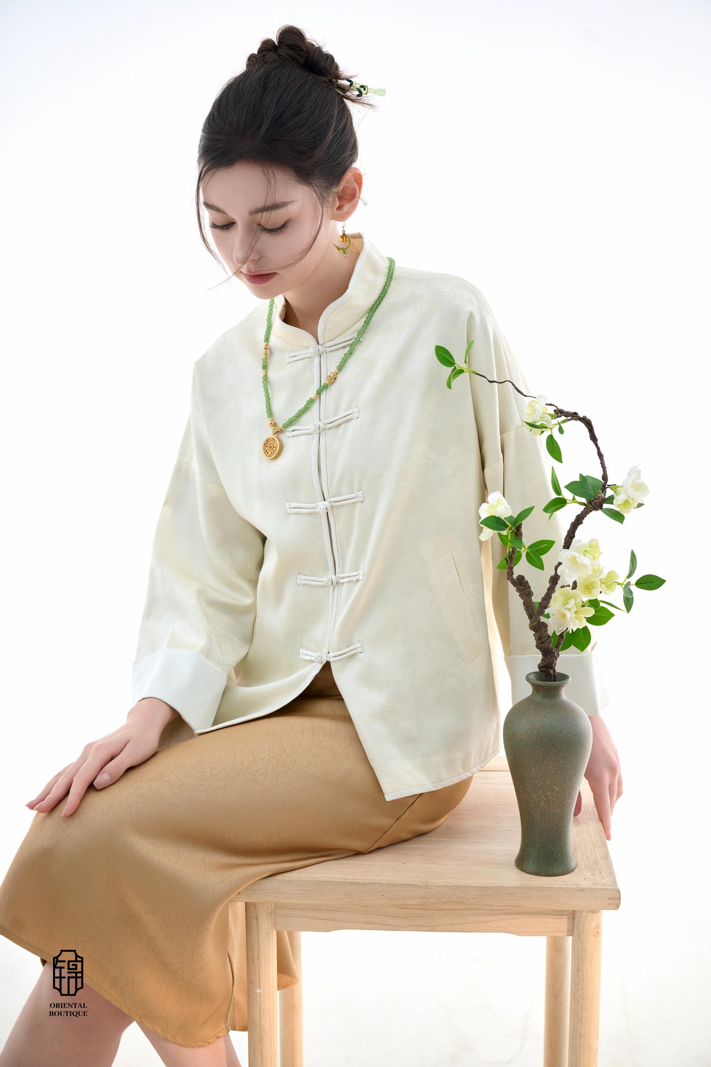 Elegant Cloud Brocade Jacket,The Elegant Cloud Brocade Jacket is crafted in a soft ivory tone with subtle cloud patterns woven into the fabric, exuding a sense of understated luxury. The jacket’s loose fit, combined with traditional frog button closures,