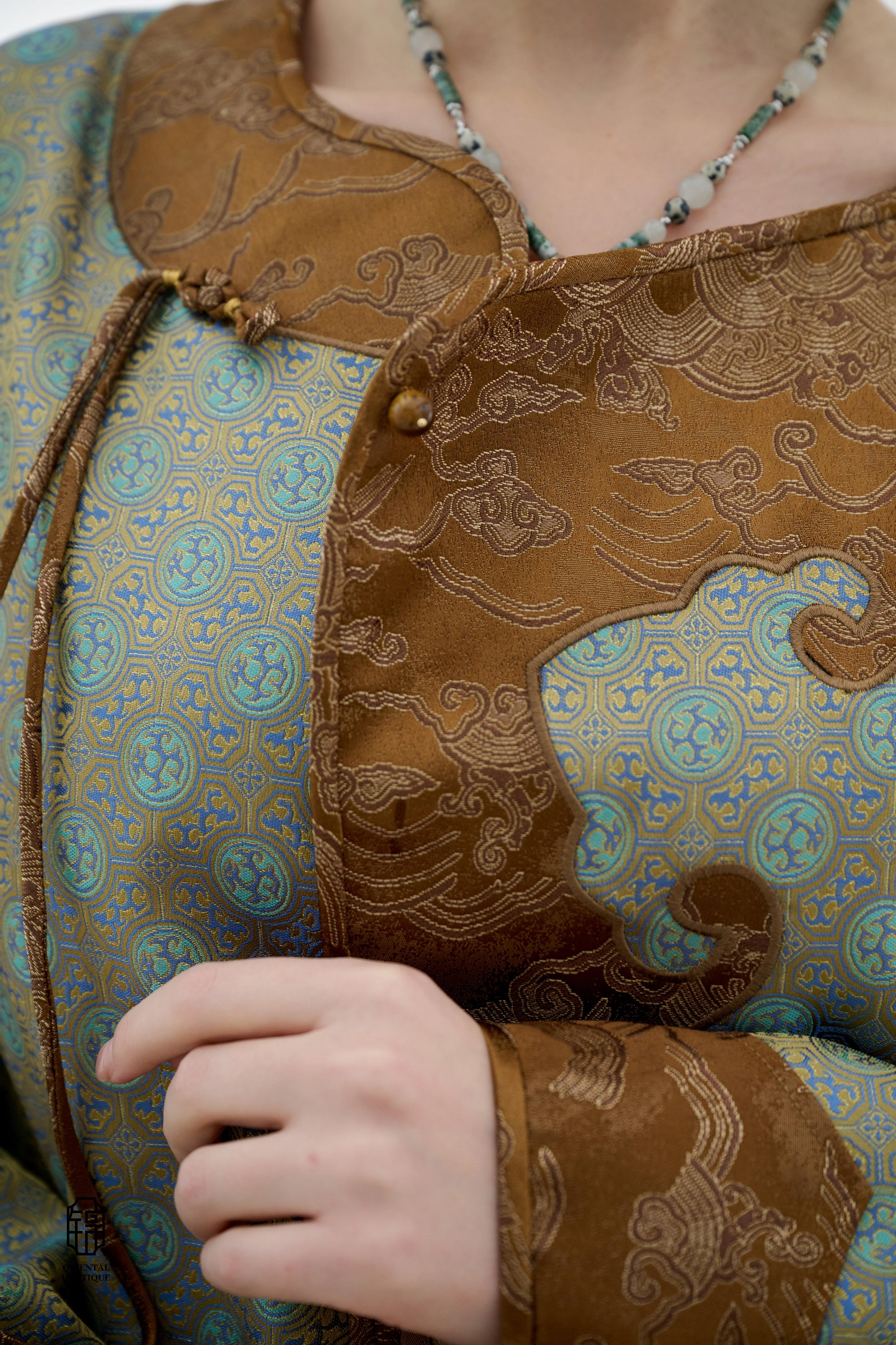 Azure Cloud Pattern Jacket,The Azure Cloud Pattern Jacket blends classical aesthetics with modern tailoring, drawing inspiration from the traditional Chinese blue and white porcelain motifs. The light blue and pale gold brocade fabric resembles the flowin