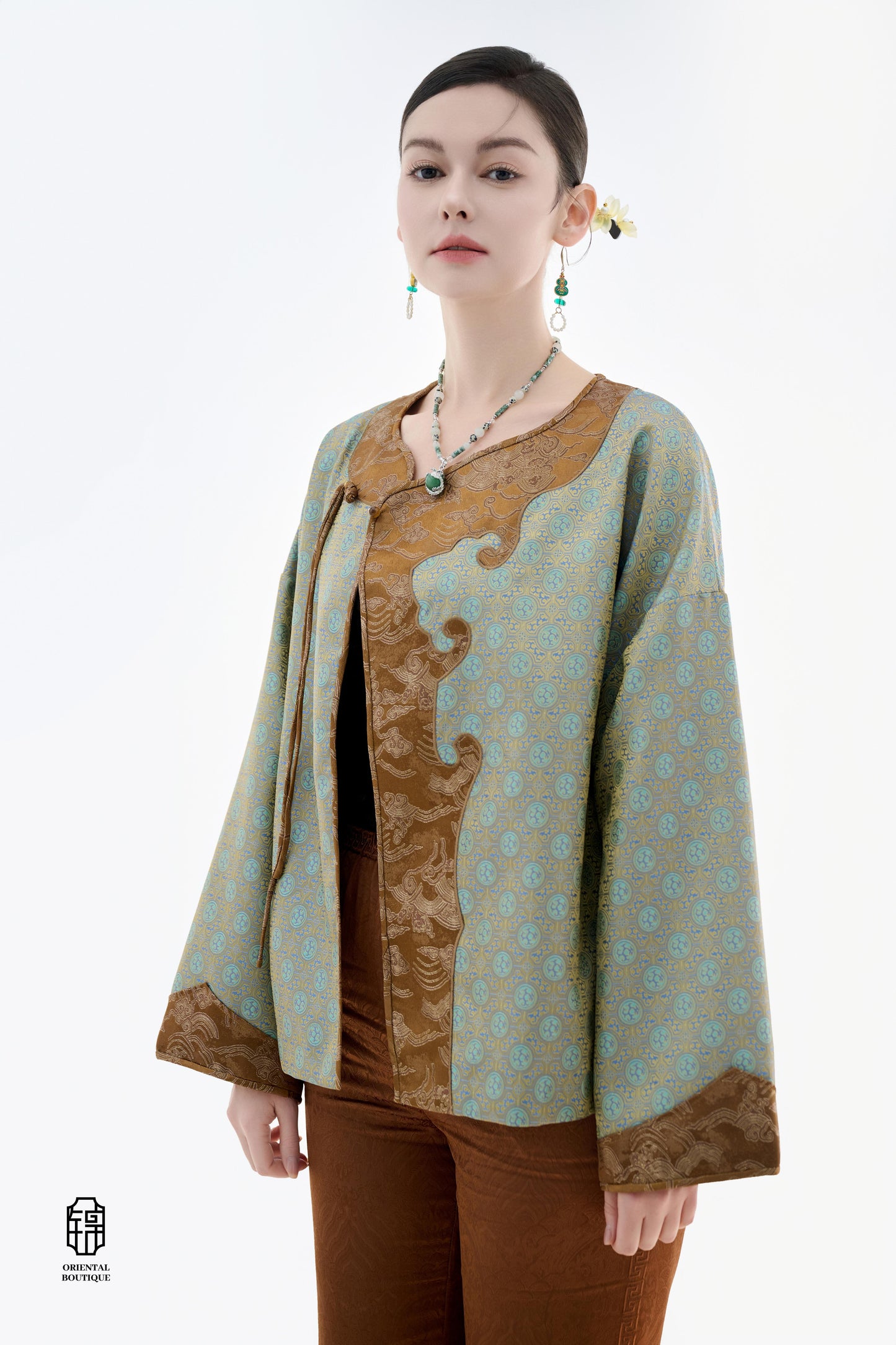 Azure Cloud Pattern Jacket,The Azure Cloud Pattern Jacket blends classical aesthetics with modern tailoring, drawing inspiration from the traditional Chinese blue and white porcelain motifs. The light blue and pale gold brocade fabric resembles the flowin