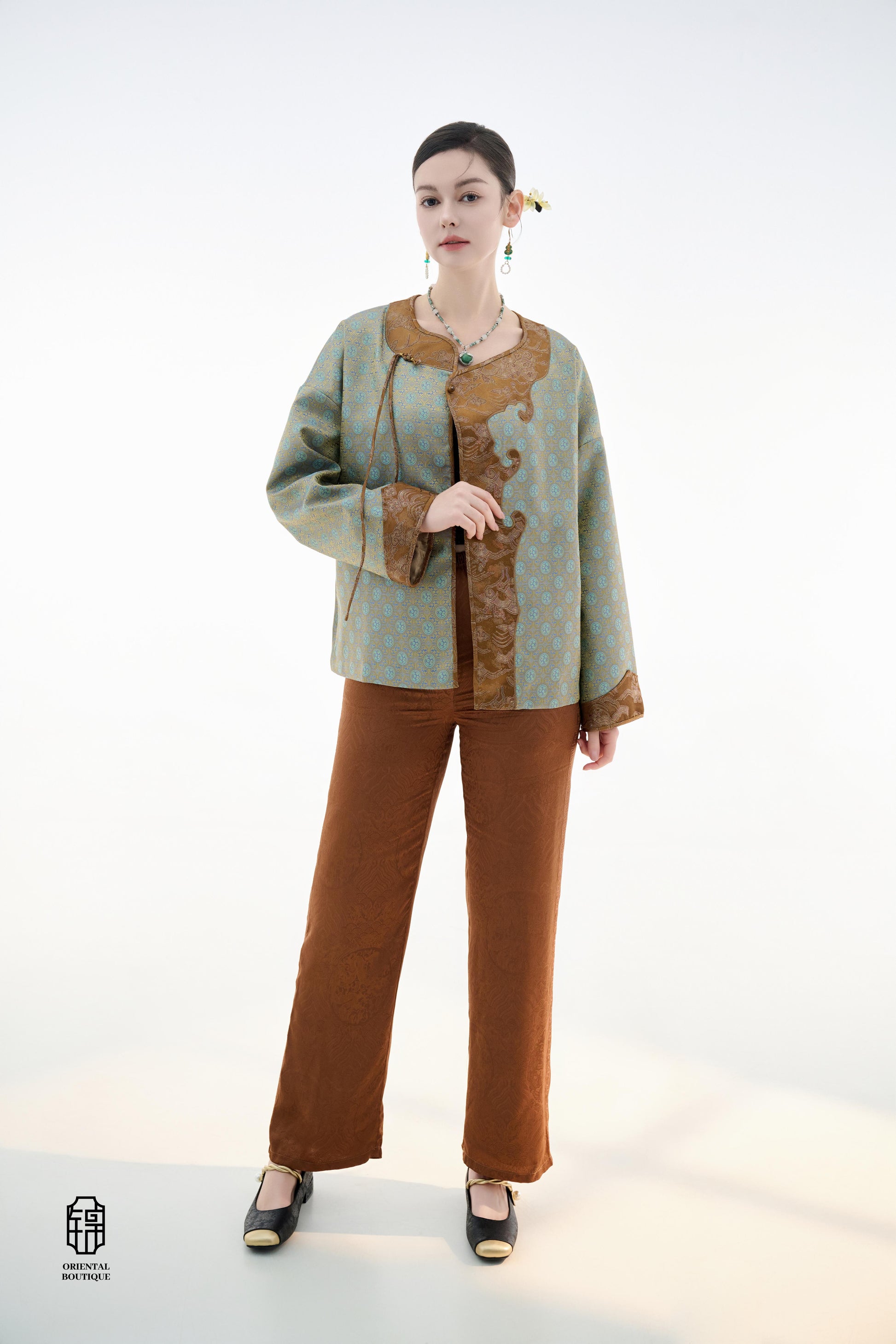 Azure Cloud Pattern Jacket,The Azure Cloud Pattern Jacket blends classical aesthetics with modern tailoring, drawing inspiration from the traditional Chinese blue and white porcelain motifs. The light blue and pale gold brocade fabric resembles the flowin