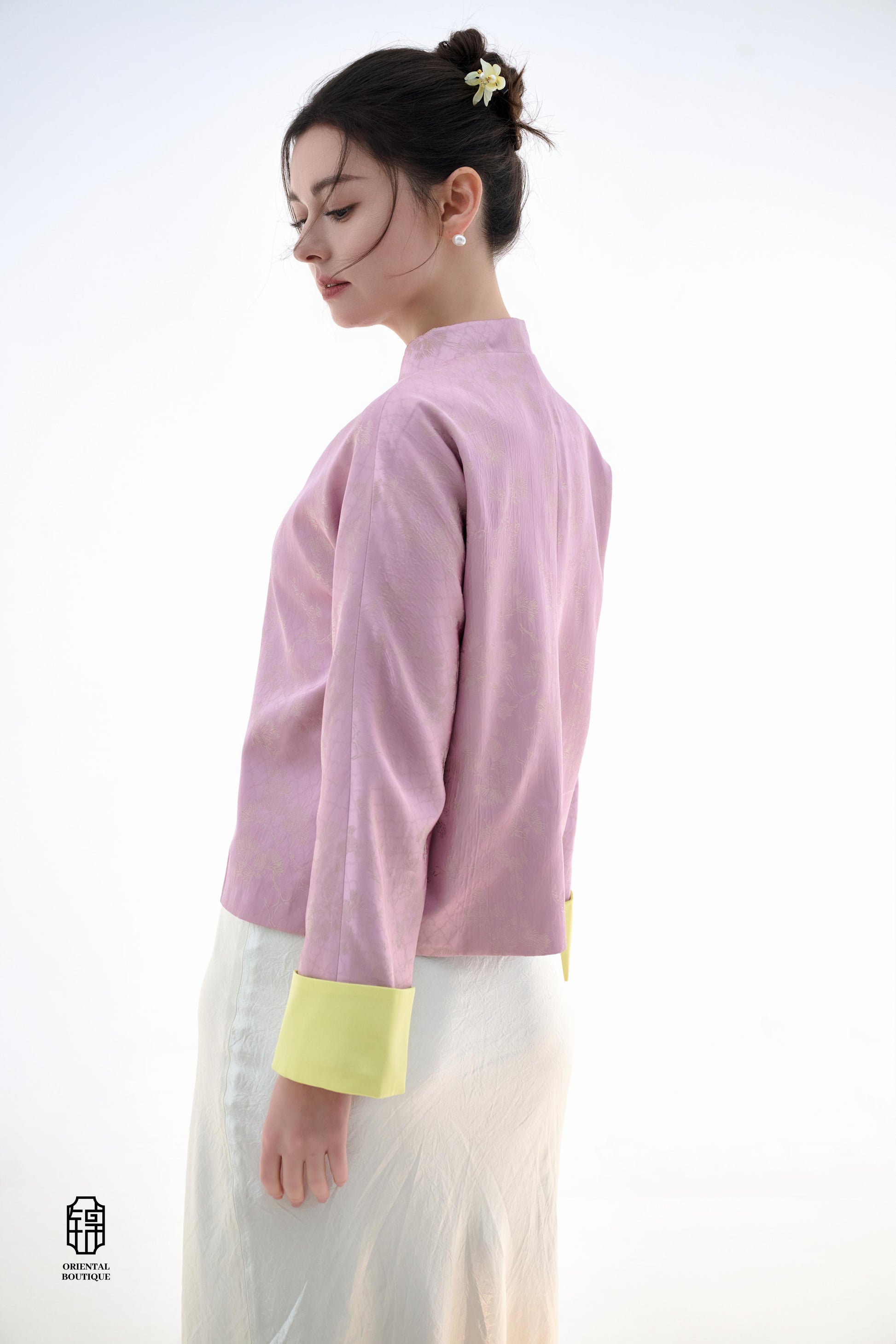 Golden Silk Purple Blouse,The Sakura Silk Brocade Blouse features a soft pink silk base adorned with delicate jacquard patterns, exuding an elegant and gentle charm. The pale yellow cuff details add a pop of brightness, breaking the monotony and enhancing