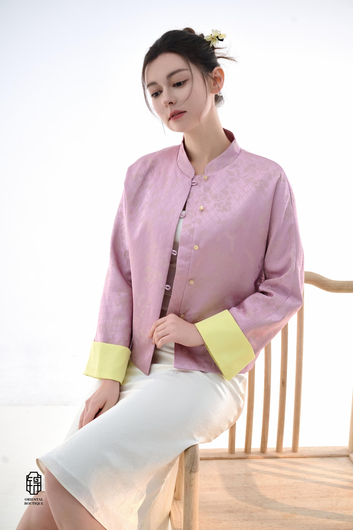 Golden Silk Purple Blouse,The Sakura Silk Brocade Blouse features a soft pink silk base adorned with delicate jacquard patterns, exuding an elegant and gentle charm. The pale yellow cuff details add a pop of brightness, breaking the monotony and enhancing