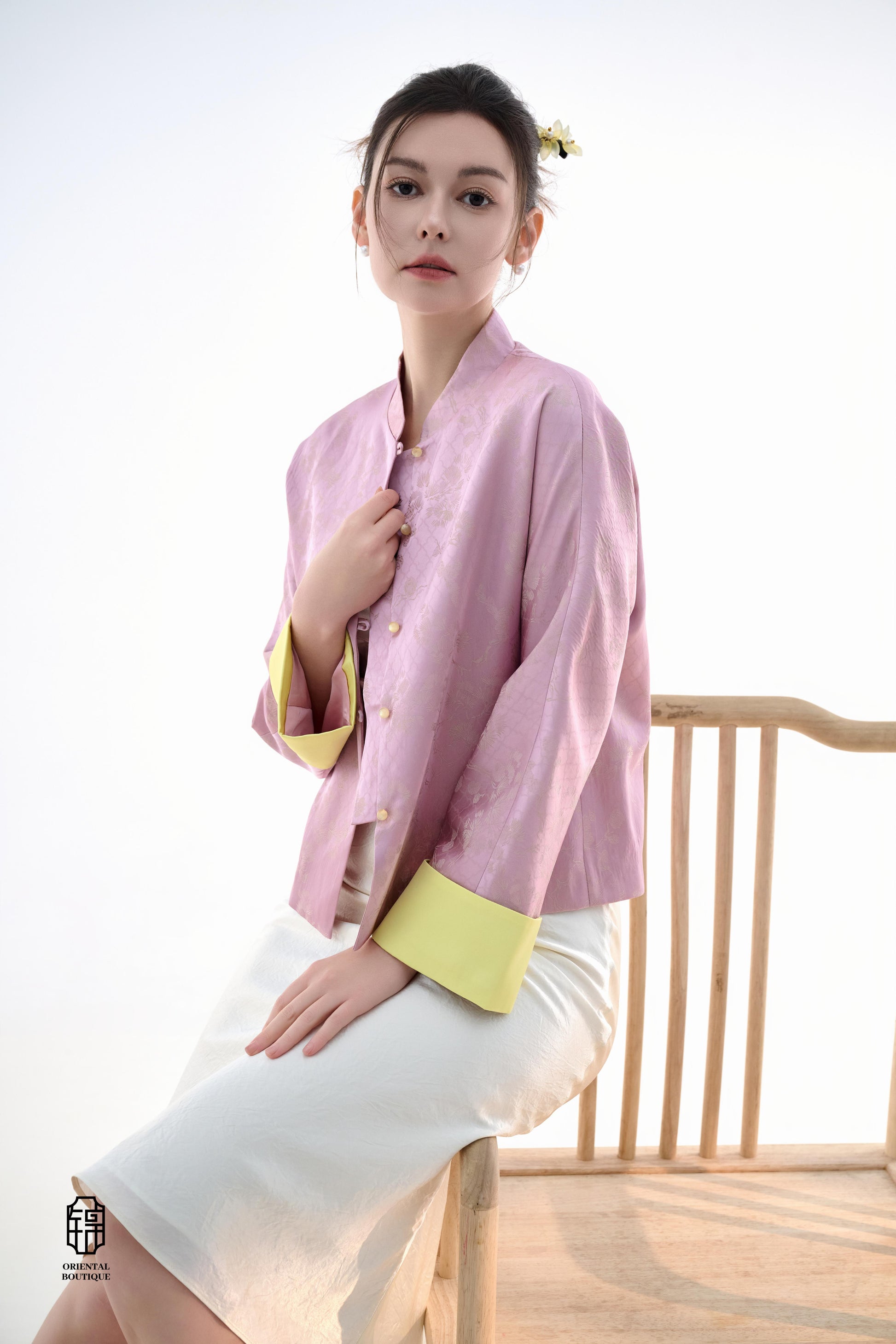 Golden Silk Purple Blouse,The Sakura Silk Brocade Blouse features a soft pink silk base adorned with delicate jacquard patterns, exuding an elegant and gentle charm. The pale yellow cuff details add a pop of brightness, breaking the monotony and enhancing