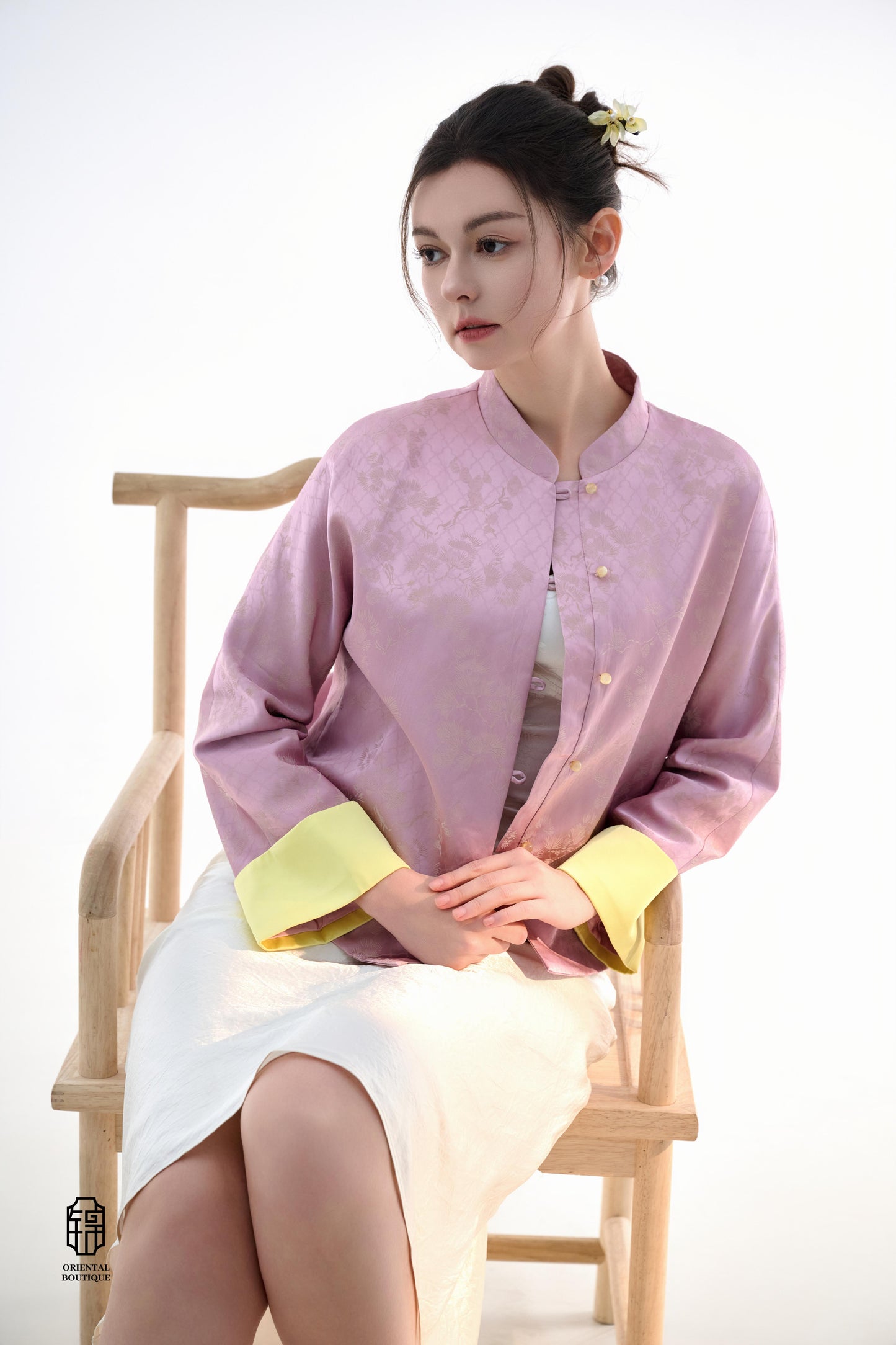 Golden Silk Purple Blouse,The Sakura Silk Brocade Blouse features a soft pink silk base adorned with delicate jacquard patterns, exuding an elegant and gentle charm. The pale yellow cuff details add a pop of brightness, breaking the monotony and enhancing