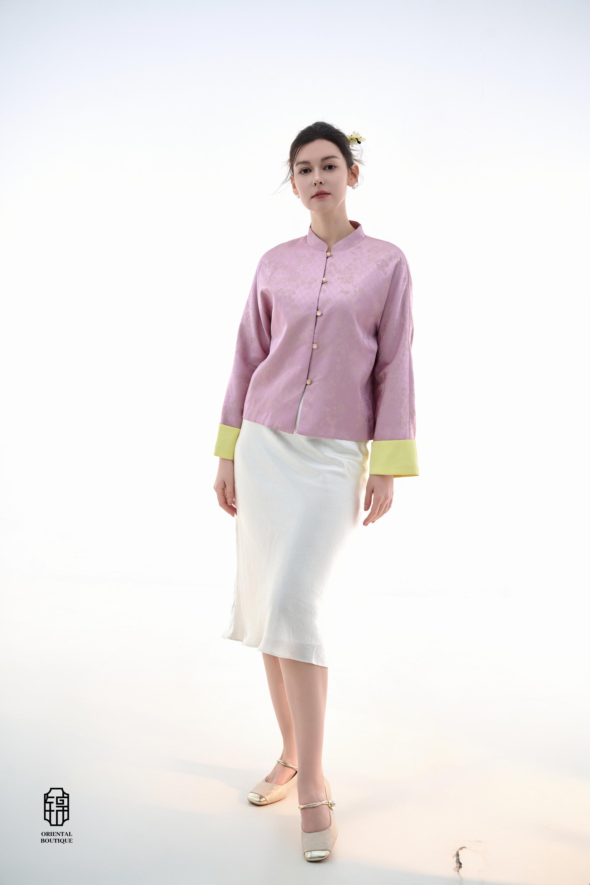 Golden Silk Purple Blouse,The Sakura Silk Brocade Blouse features a soft pink silk base adorned with delicate jacquard patterns, exuding an elegant and gentle charm. The pale yellow cuff details add a pop of brightness, breaking the monotony and enhancing