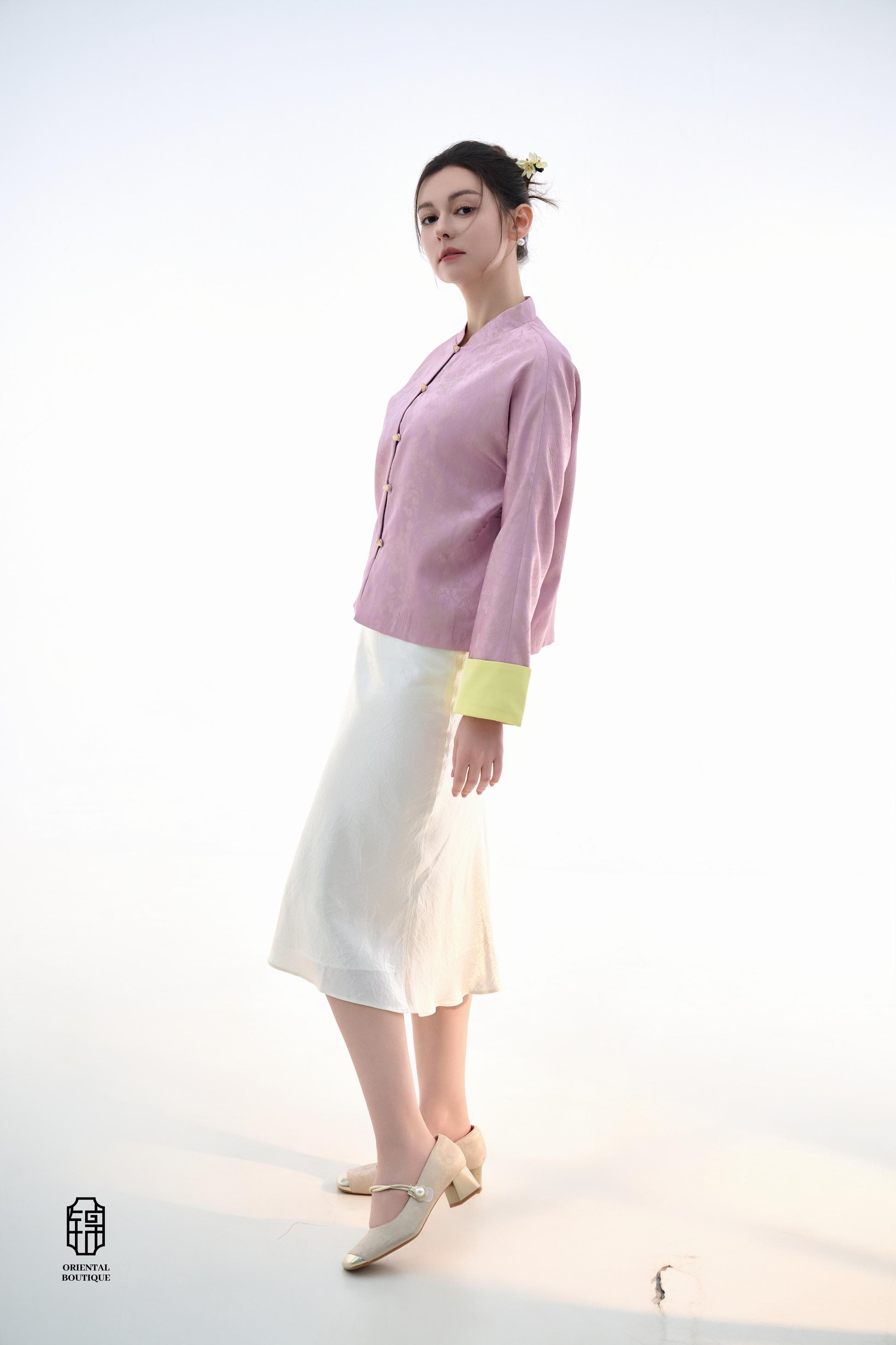 Golden Silk Purple Blouse,The Sakura Silk Brocade Blouse features a soft pink silk base adorned with delicate jacquard patterns, exuding an elegant and gentle charm. The pale yellow cuff details add a pop of brightness, breaking the monotony and enhancing