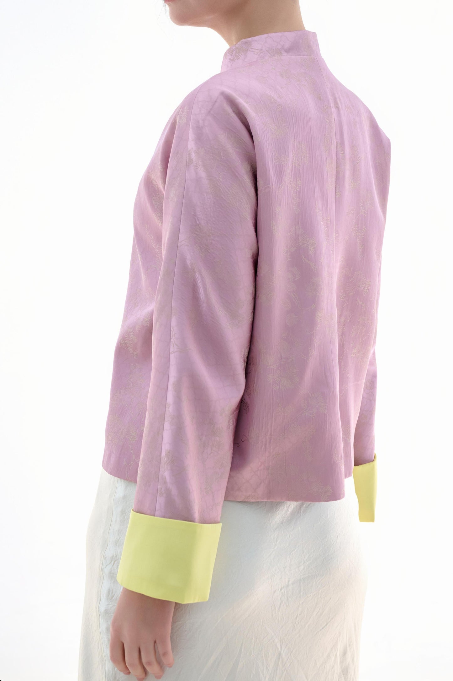 Golden Silk Purple Blouse,The Sakura Silk Brocade Blouse features a soft pink silk base adorned with delicate jacquard patterns, exuding an elegant and gentle charm. The pale yellow cuff details add a pop of brightness, breaking the monotony and enhancing