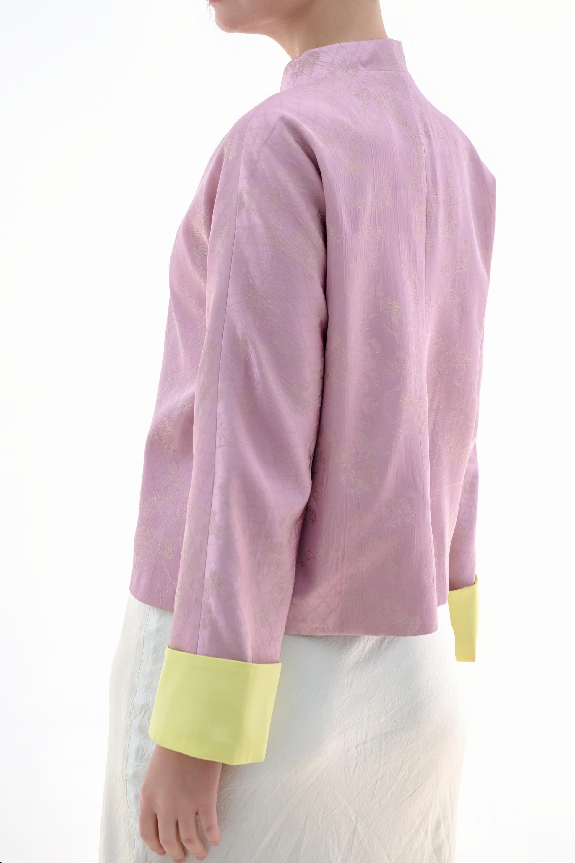 Golden Silk Purple Blouse,The Sakura Silk Brocade Blouse features a soft pink silk base adorned with delicate jacquard patterns, exuding an elegant and gentle charm. The pale yellow cuff details add a pop of brightness, breaking the monotony and enhancing