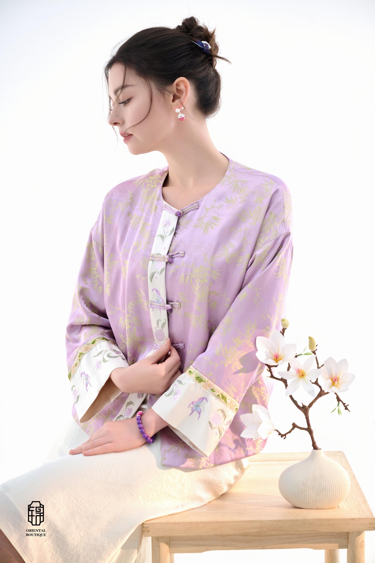 Lavender Bamboo Grace Jacket,The Lavender Bamboo Grace Jacket is made from soft lavender silk fabric, delicately embroidered with bamboo leaf patterns that evoke freshness and elegance. The cuffs and collar are lined with floral accents, adding a layer of