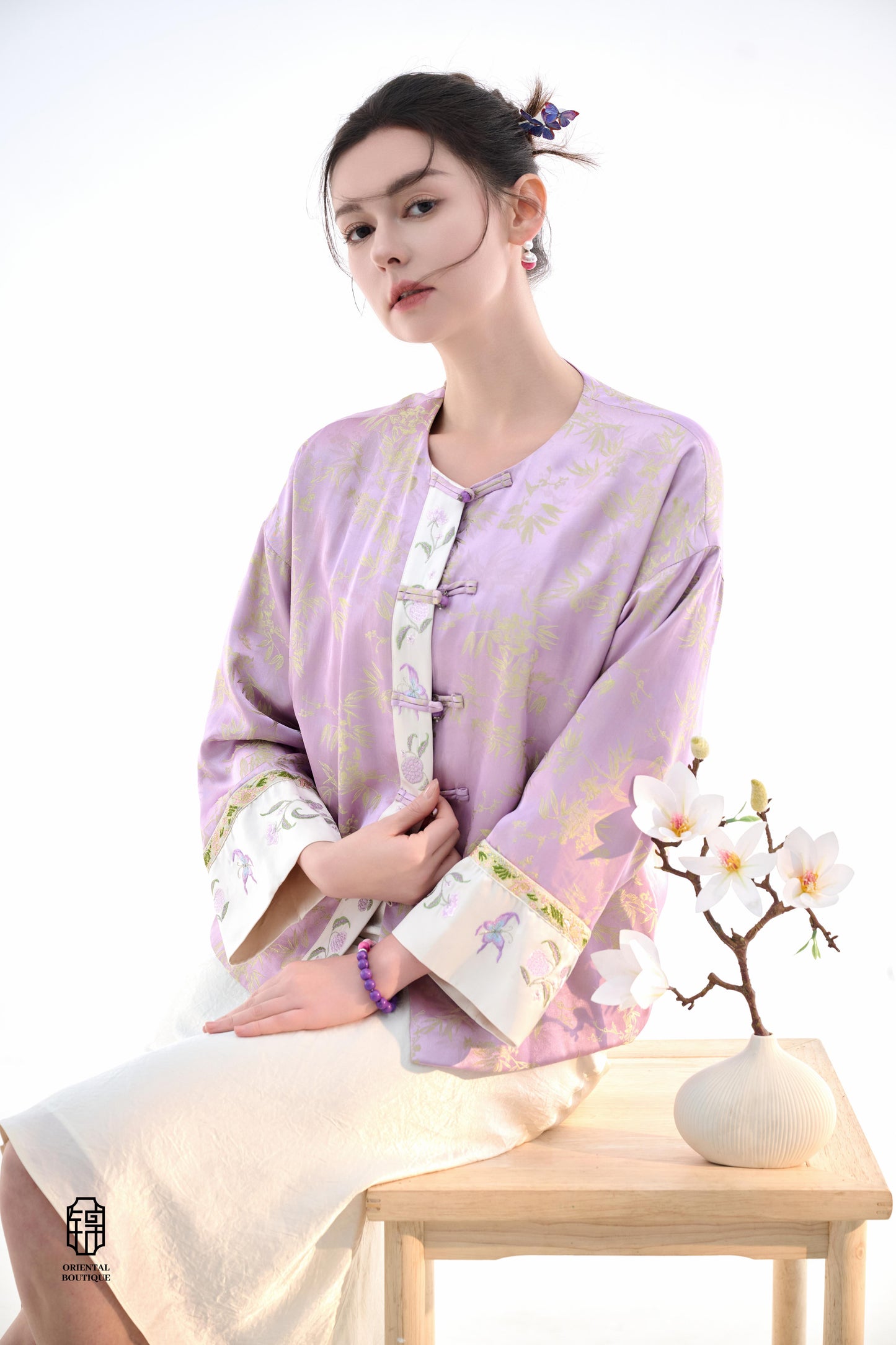 Lavender Bamboo Grace Jacket,The Lavender Bamboo Grace Jacket is made from soft lavender silk fabric, delicately embroidered with bamboo leaf patterns that evoke freshness and elegance. The cuffs and collar are lined with floral accents, adding a layer of