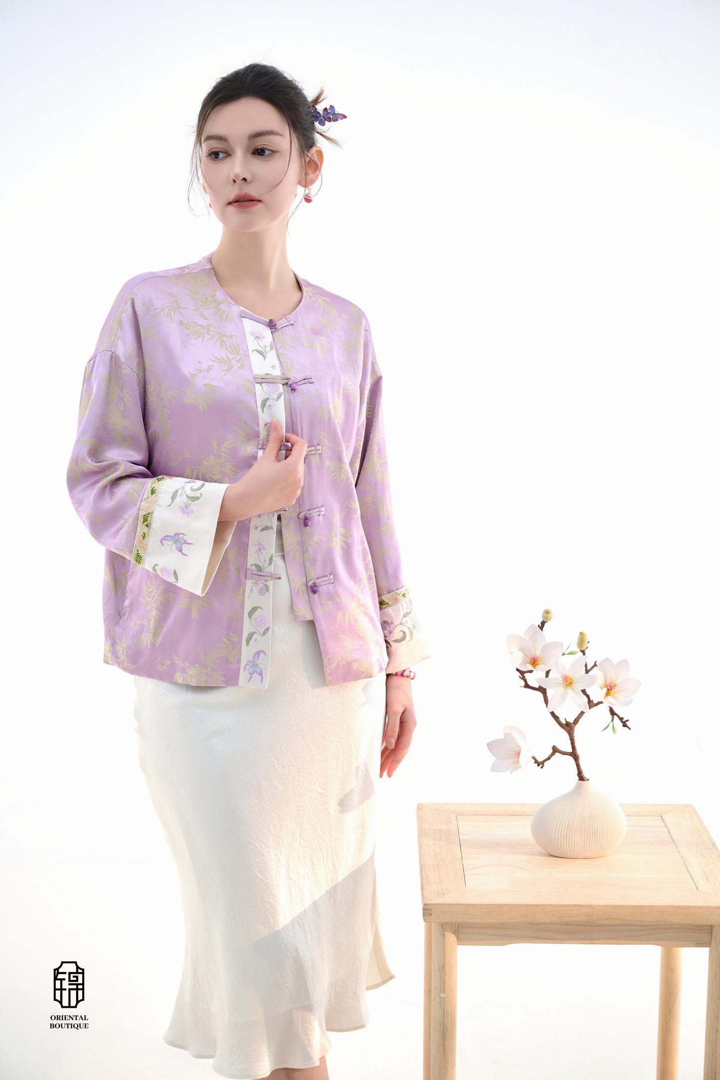 Lavender Bamboo Grace Jacket,The Lavender Bamboo Grace Jacket is made from soft lavender silk fabric, delicately embroidered with bamboo leaf patterns that evoke freshness and elegance. The cuffs and collar are lined with floral accents, adding a layer of