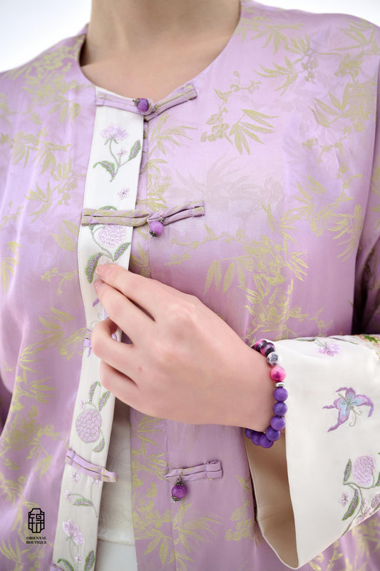 Lavender Bamboo Grace Jacket,The Lavender Bamboo Grace Jacket is made from soft lavender silk fabric, delicately embroidered with bamboo leaf patterns that evoke freshness and elegance. The cuffs and collar are lined with floral accents, adding a layer of