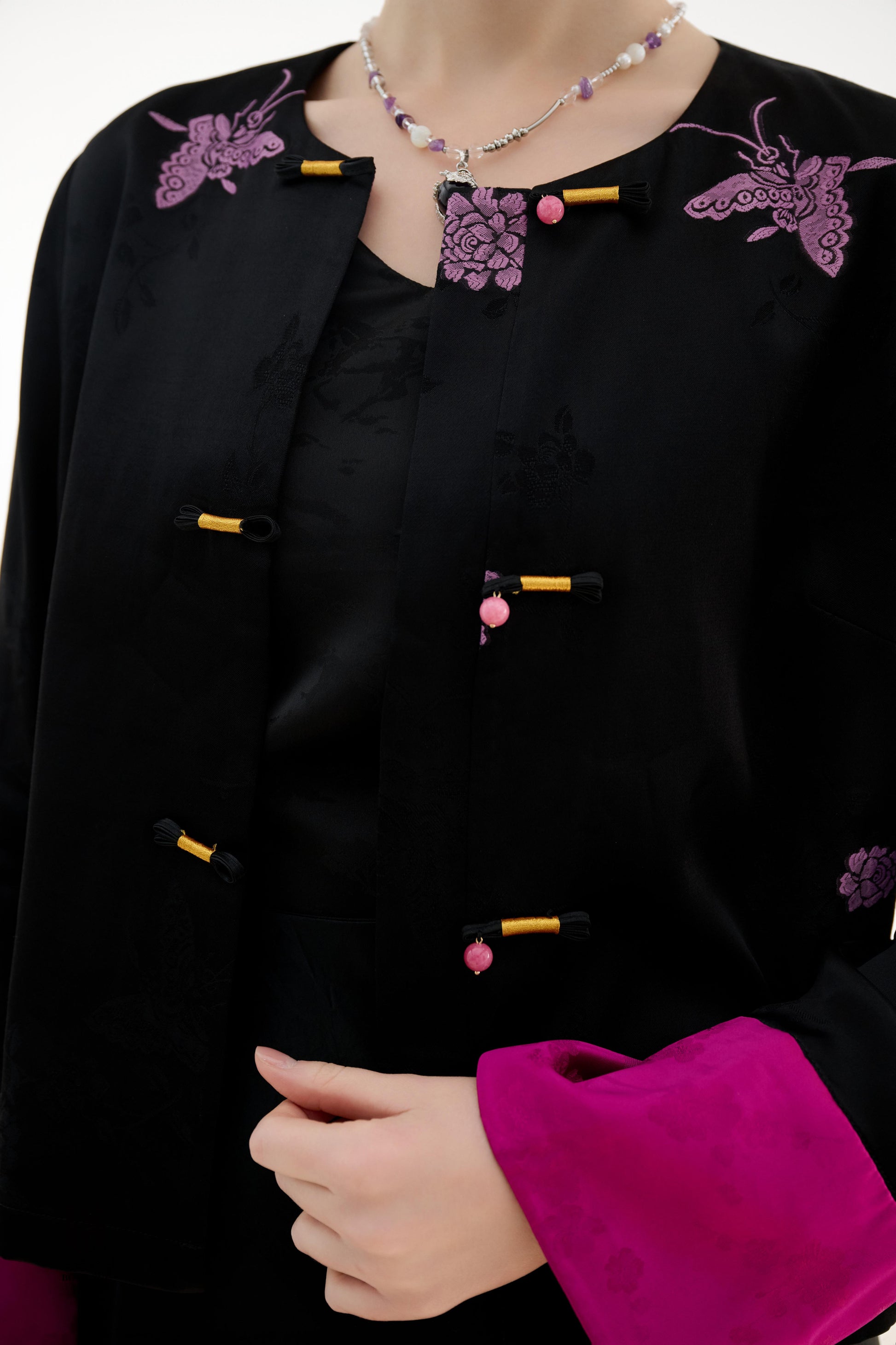 Purple Butterfly Grace Jacket,The Purple Butterfly Grace Jacket is a black outerwear piece that blends classical and modern aesthetics. Adorned with delicate purple butterfly and floral embroidery, it symbolizes elegance and romance. The unique button des