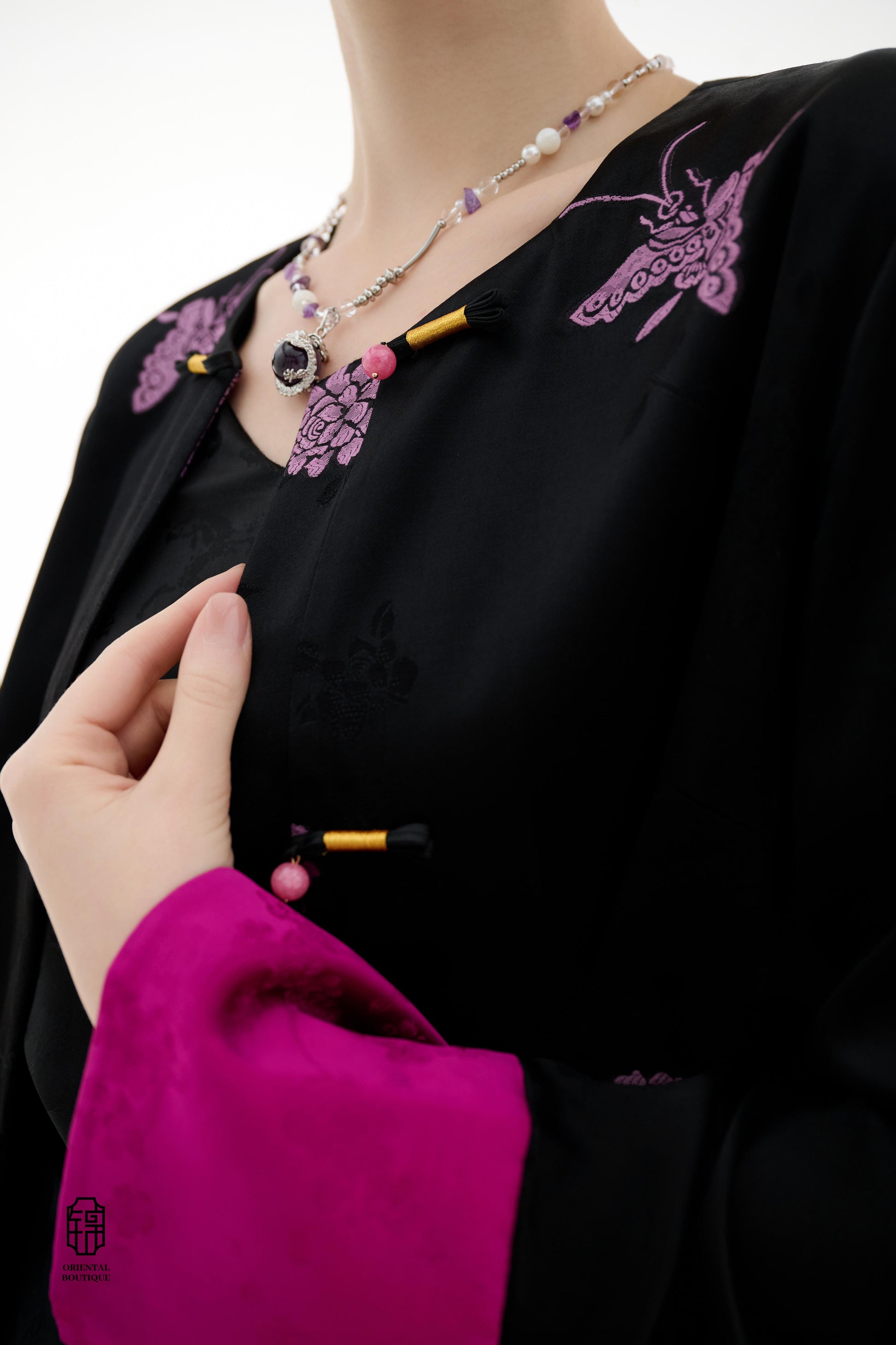 Purple Butterfly Grace Jacket,The Purple Butterfly Grace Jacket is a black outerwear piece that blends classical and modern aesthetics. Adorned with delicate purple butterfly and floral embroidery, it symbolizes elegance and romance. The unique button des