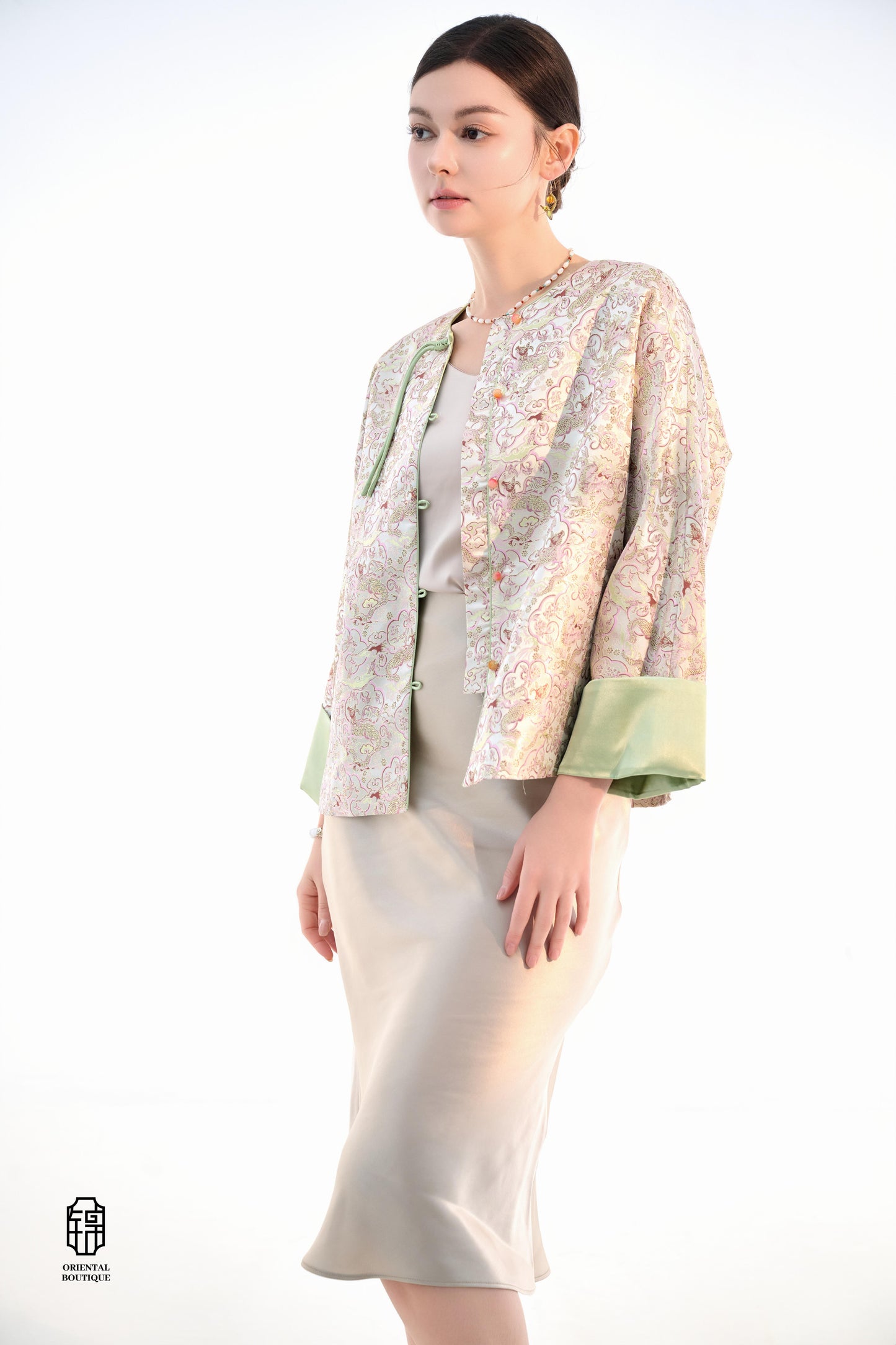 Emerald Blossom Brocade Jacket,The Emerald Blossom Brocade Jacket is crafted from light silk fabric, featuring a refined and elegant design. The jacket is adorned with intricate floral patterns, reminiscent of a sea of blossoms, highlighting the delicate