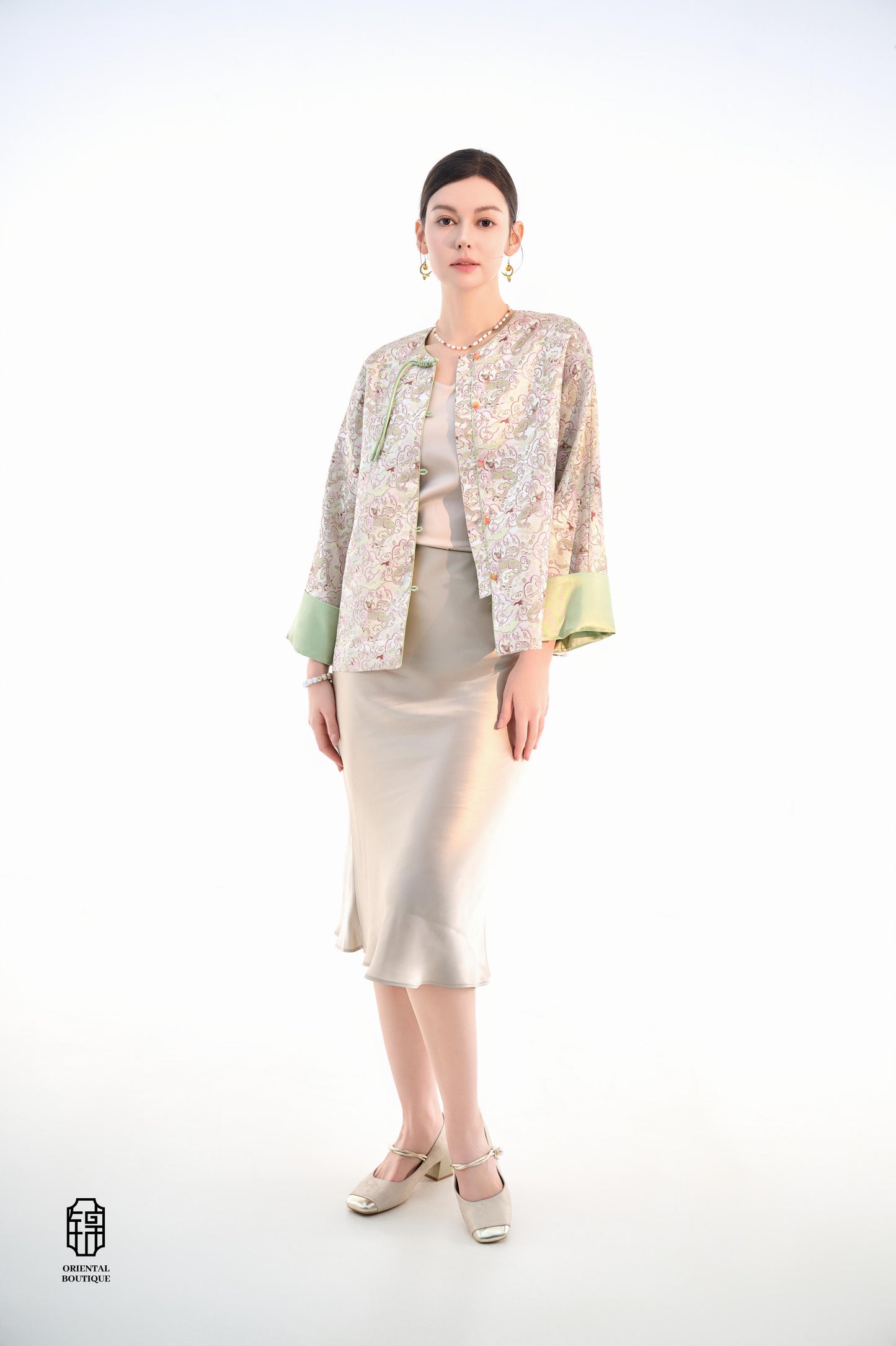Emerald Blossom Brocade Jacket,The Emerald Blossom Brocade Jacket is crafted from light silk fabric, featuring a refined and elegant design. The jacket is adorned with intricate floral patterns, reminiscent of a sea of blossoms, highlighting the delicate
