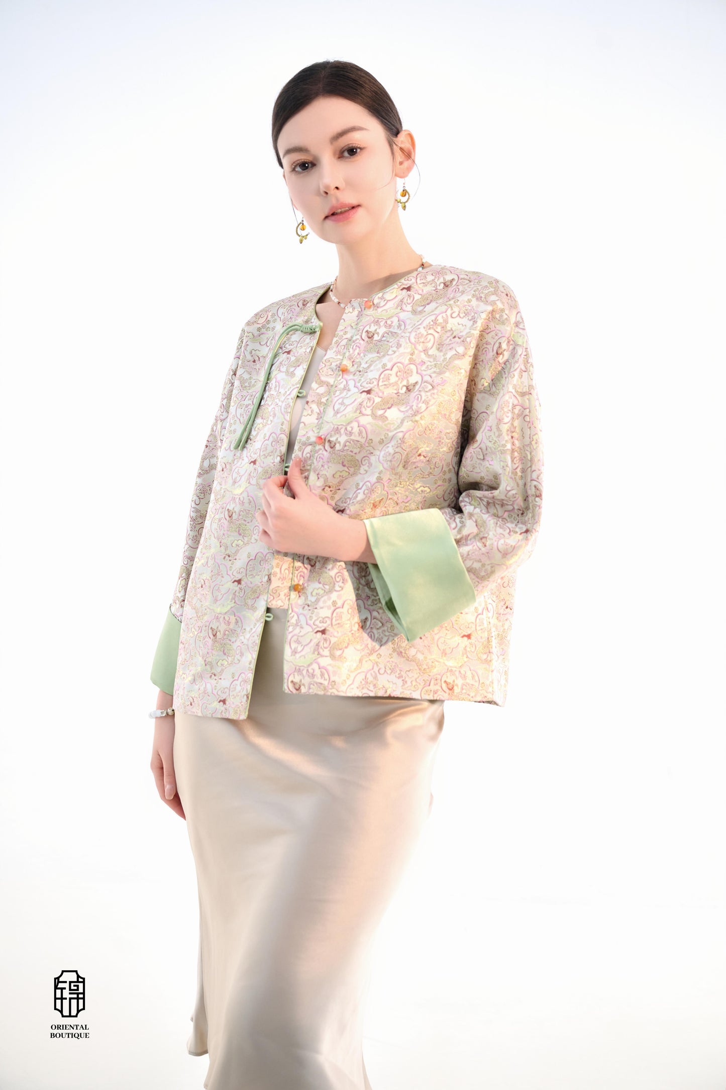 Emerald Blossom Brocade Jacket,The Emerald Blossom Brocade Jacket is crafted from light silk fabric, featuring a refined and elegant design. The jacket is adorned with intricate floral patterns, reminiscent of a sea of blossoms, highlighting the delicate