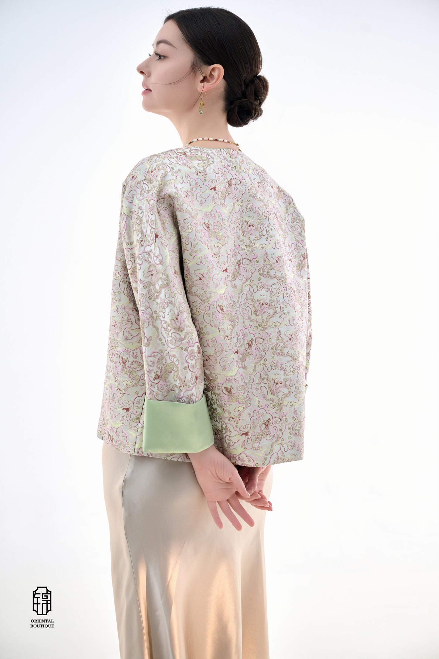 Emerald Blossom Brocade Jacket,The Emerald Blossom Brocade Jacket is crafted from light silk fabric, featuring a refined and elegant design. The jacket is adorned with intricate floral patterns, reminiscent of a sea of blossoms, highlighting the delicate