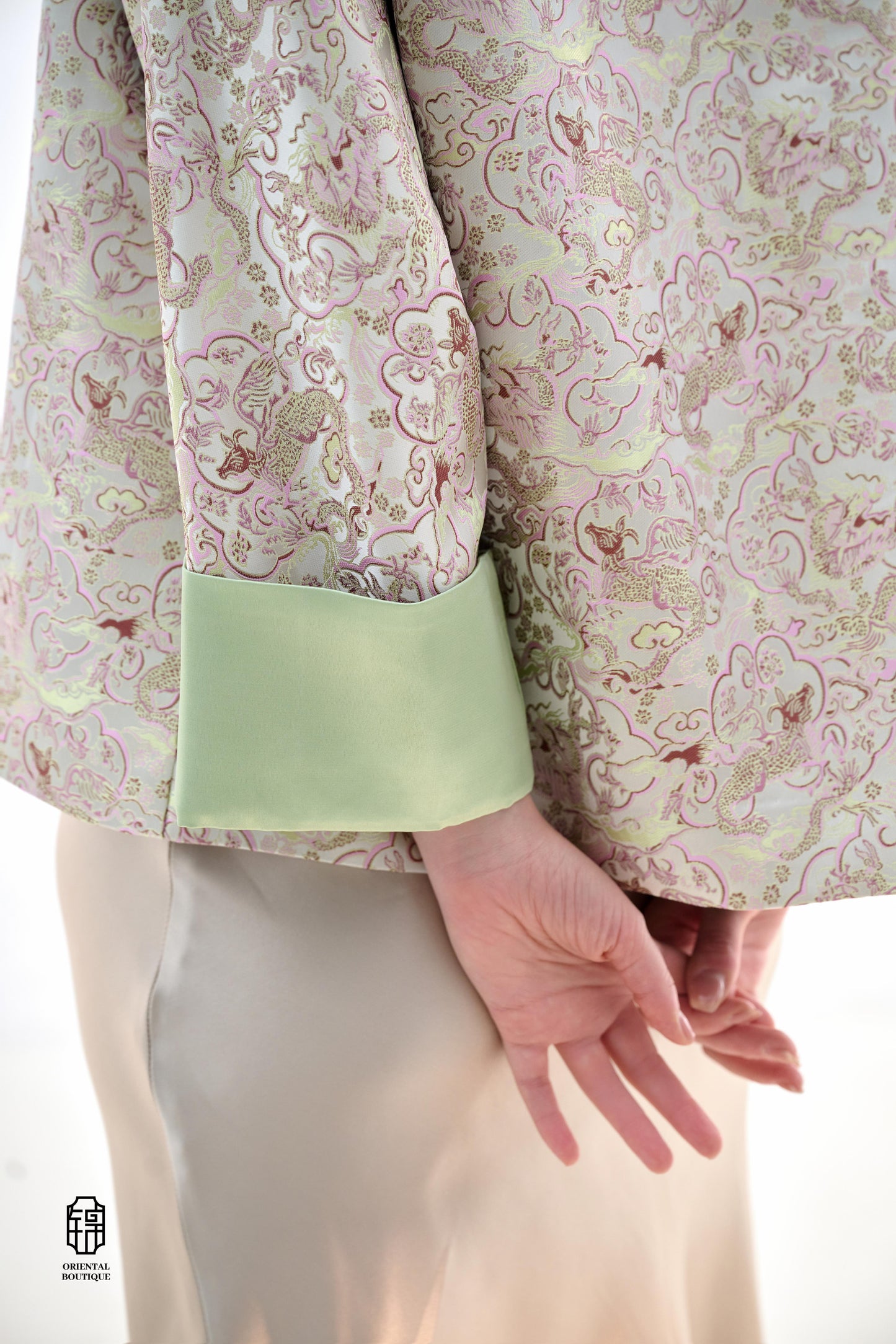 Emerald Blossom Brocade Jacket,The Emerald Blossom Brocade Jacket is crafted from light silk fabric, featuring a refined and elegant design. The jacket is adorned with intricate floral patterns, reminiscent of a sea of blossoms, highlighting the delicate
