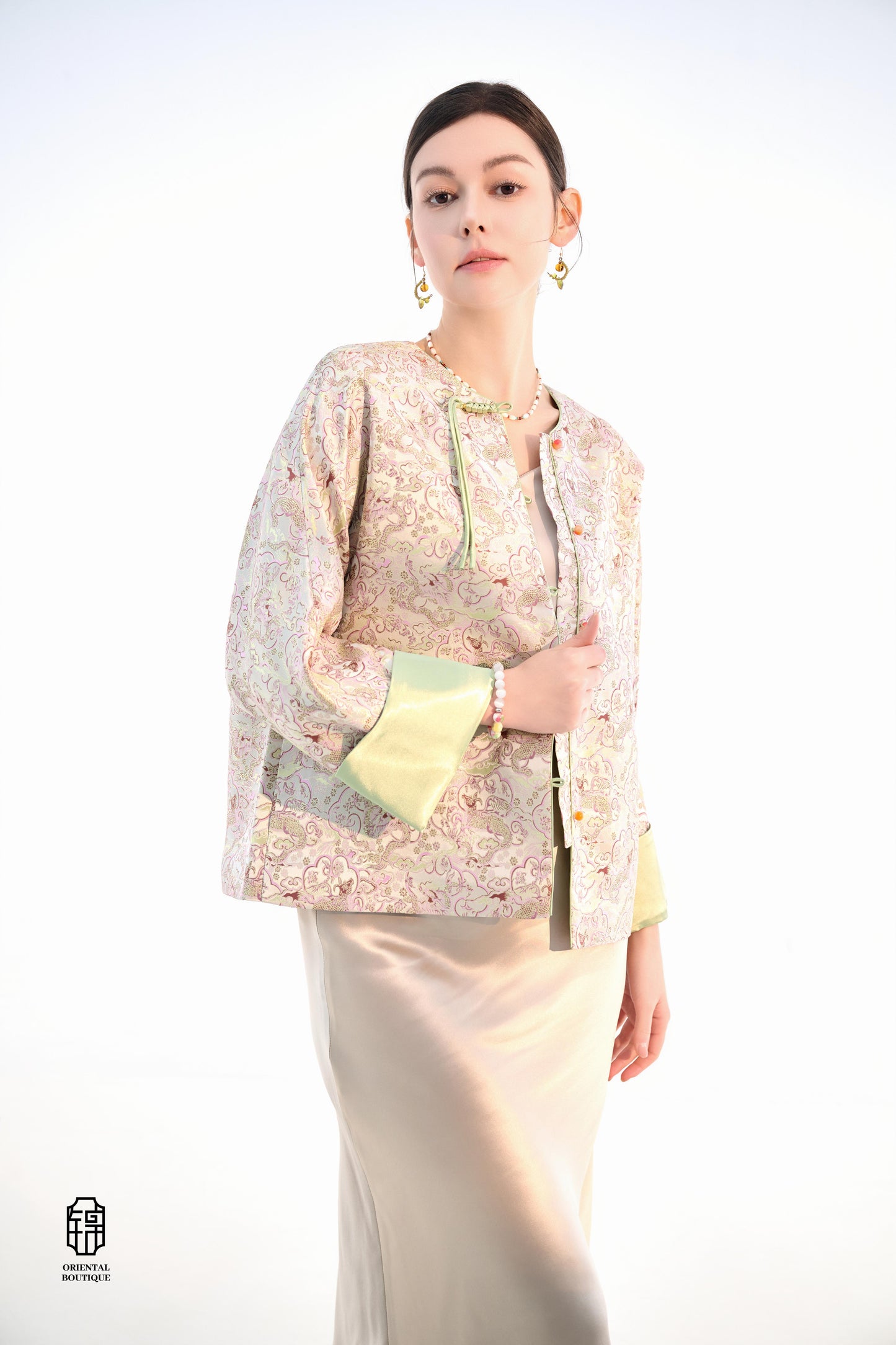 Emerald Blossom Brocade Jacket,The Emerald Blossom Brocade Jacket is crafted from light silk fabric, featuring a refined and elegant design. The jacket is adorned with intricate floral patterns, reminiscent of a sea of blossoms, highlighting the delicate