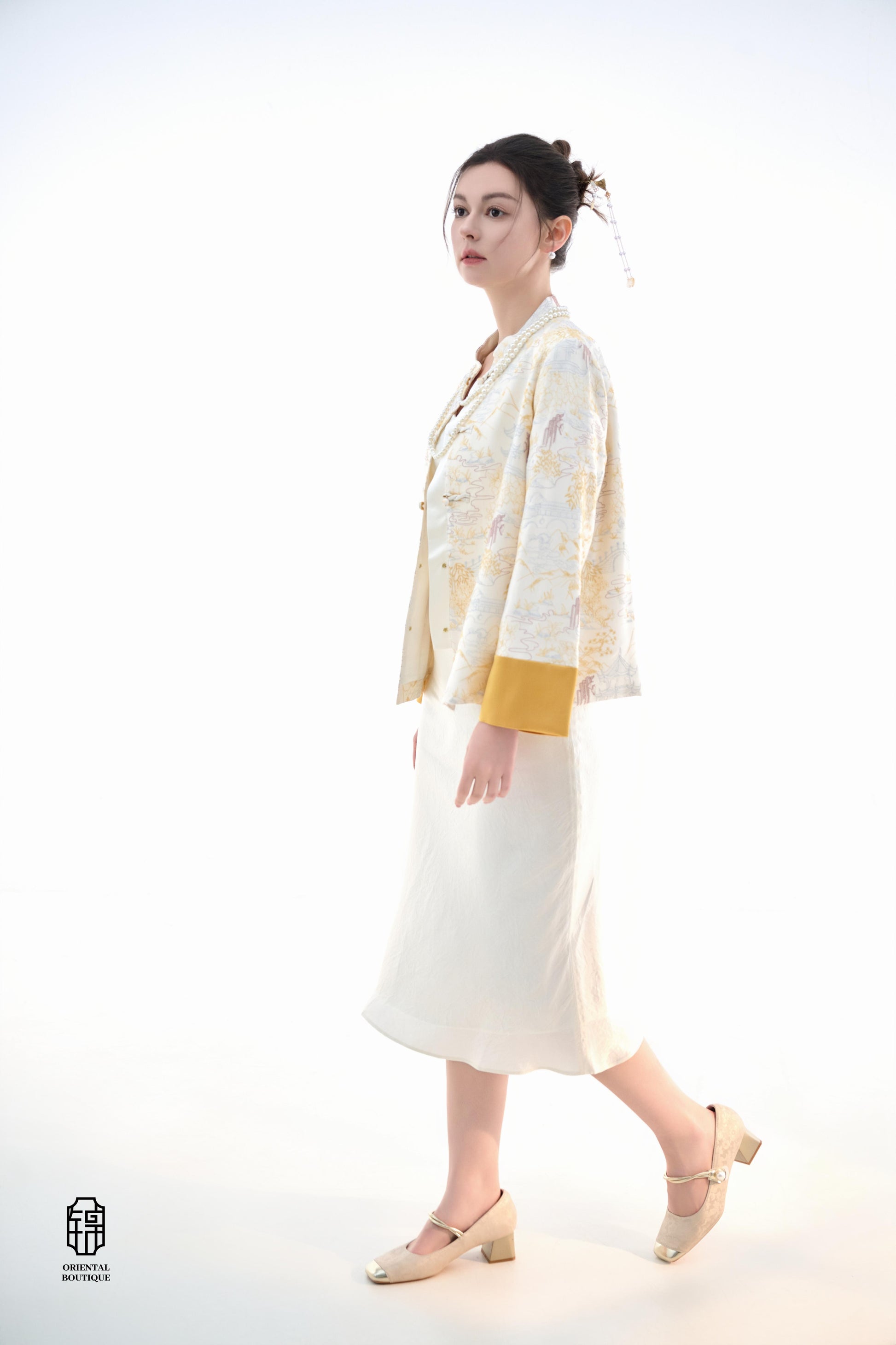 Scenic Brocade Jacket,The Scenic Brocade Jacket features intricate embroidered designs depicting traditional landscapes of mountains, pagodas, and natural scenery, showcasing an Oriental charm. With a base of soft ivory and accents of bright golden yellow