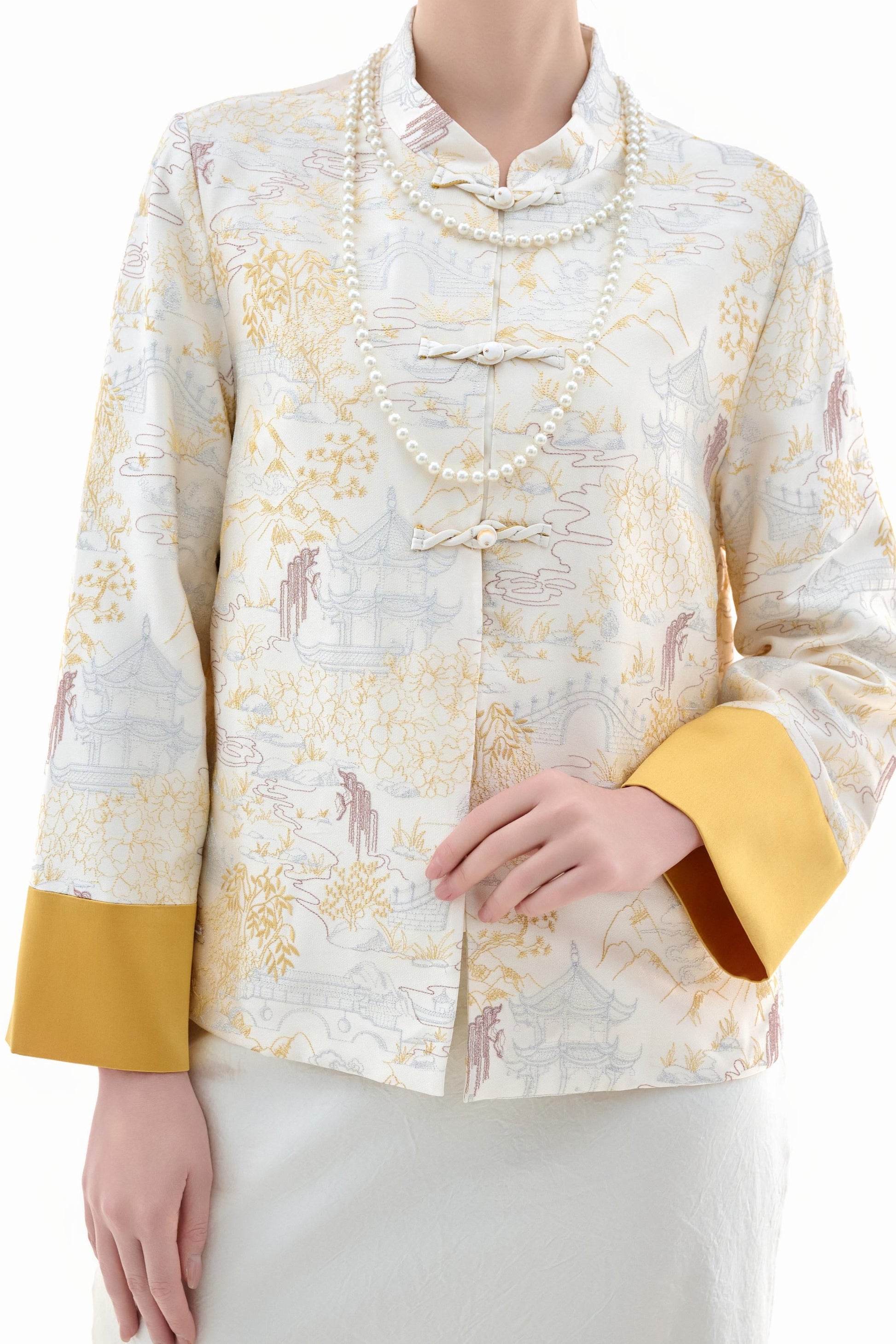 Scenic Brocade Jacket,The Scenic Brocade Jacket features intricate embroidered designs depicting traditional landscapes of mountains, pagodas, and natural scenery, showcasing an Oriental charm. With a base of soft ivory and accents of bright golden yellow