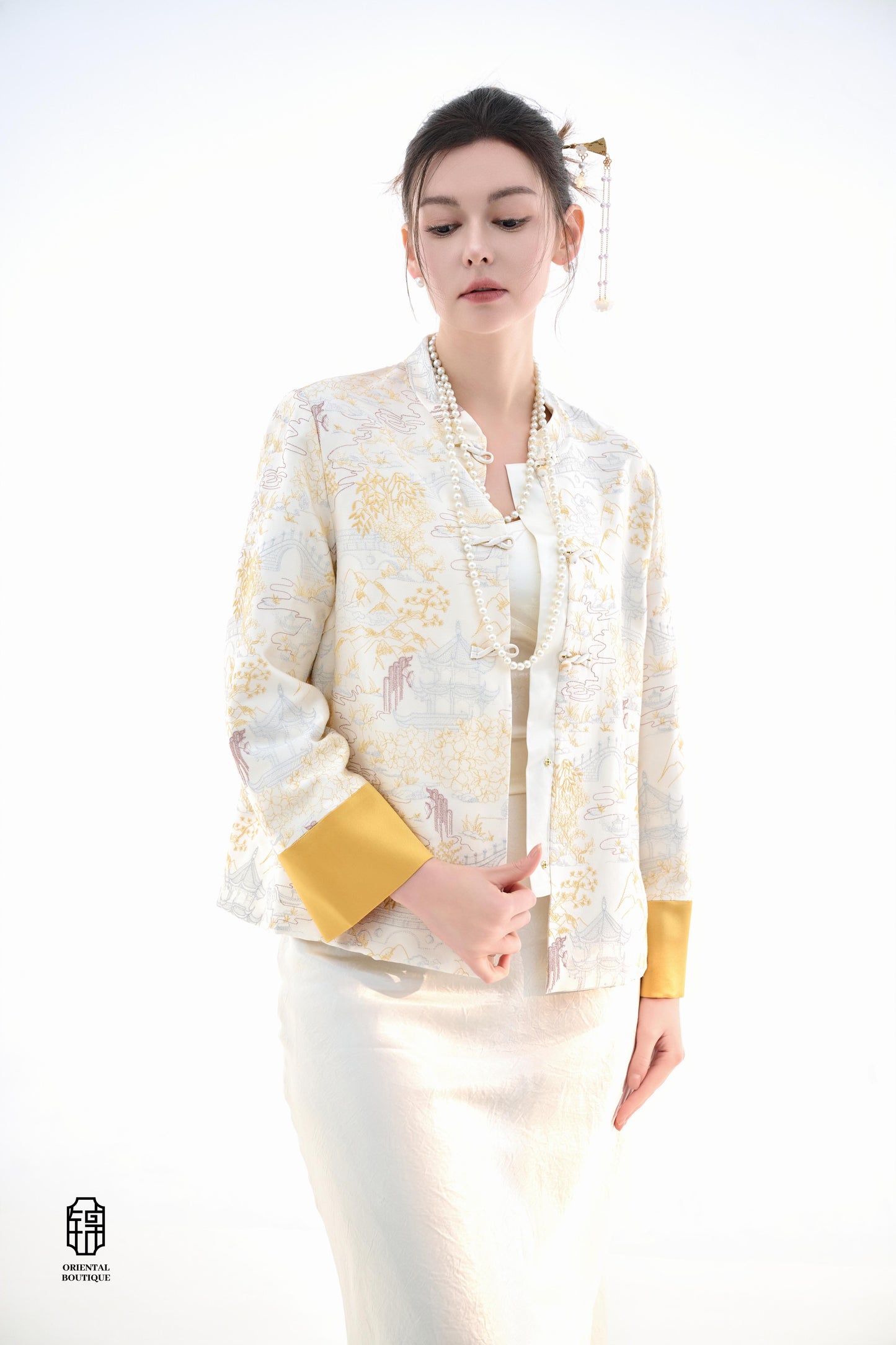 Scenic Brocade Jacket,The Scenic Brocade Jacket features intricate embroidered designs depicting traditional landscapes of mountains, pagodas, and natural scenery, showcasing an Oriental charm. With a base of soft ivory and accents of bright golden yellow