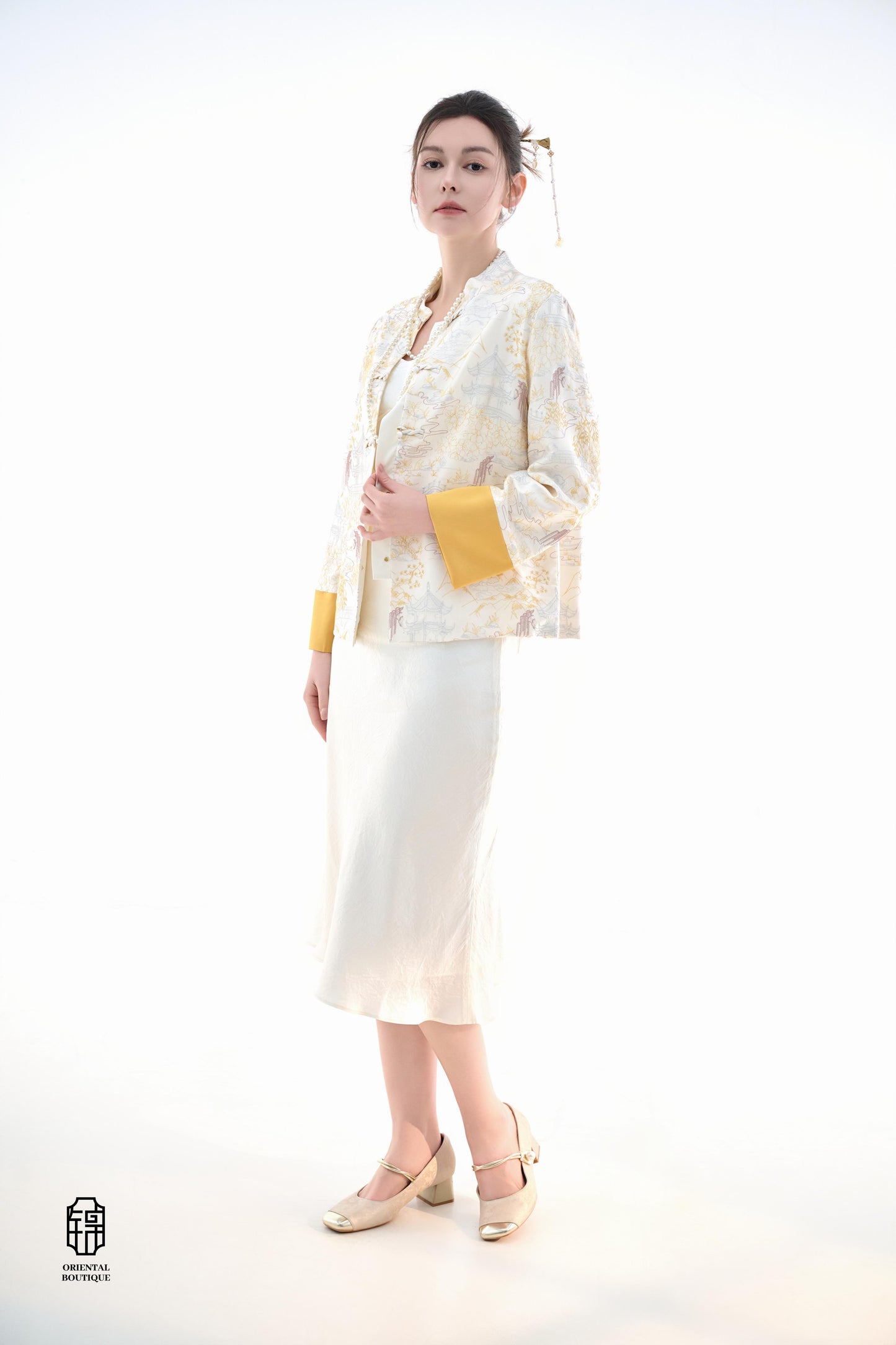 Scenic Brocade Jacket,The Scenic Brocade Jacket features intricate embroidered designs depicting traditional landscapes of mountains, pagodas, and natural scenery, showcasing an Oriental charm. With a base of soft ivory and accents of bright golden yellow