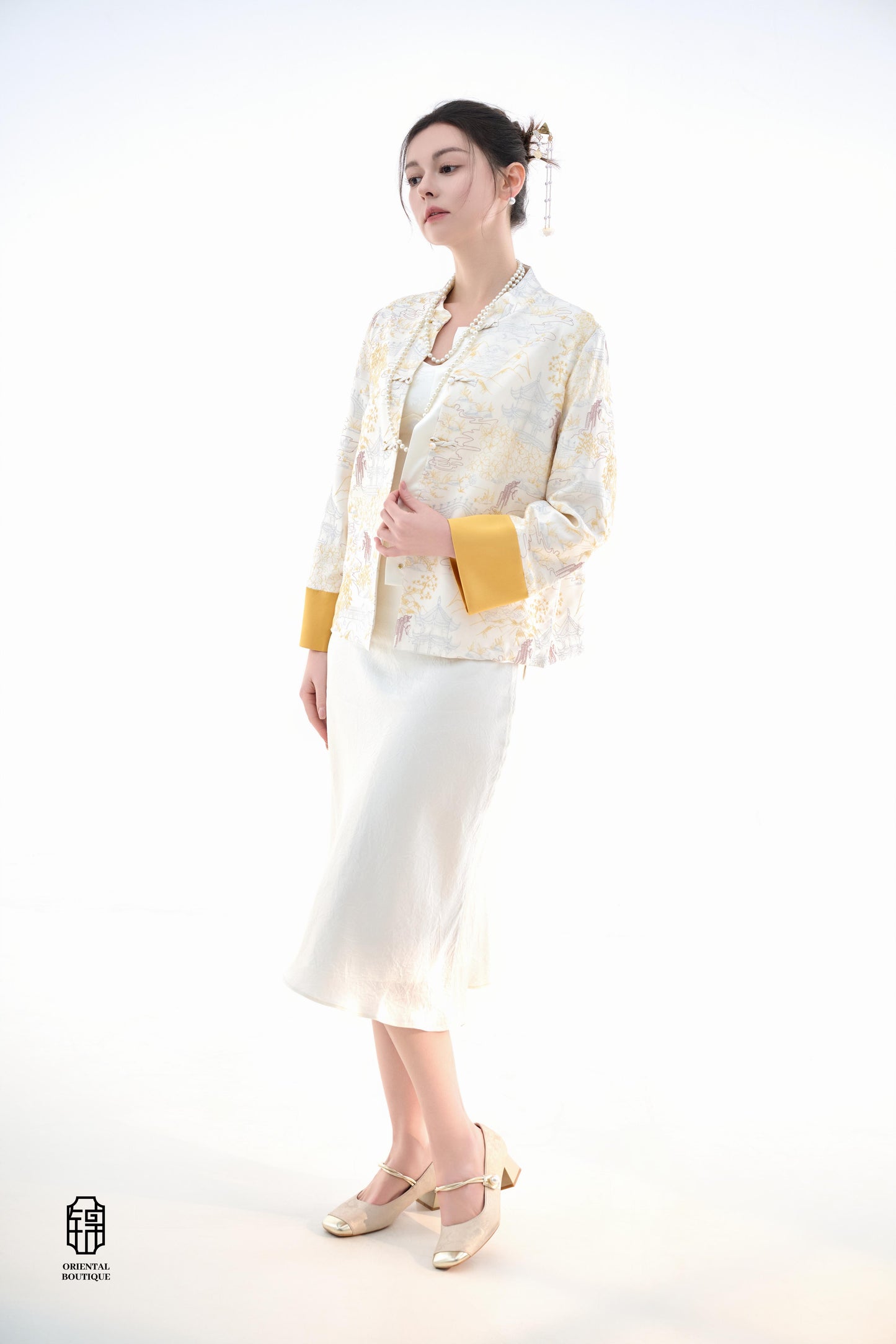 Scenic Brocade Jacket,The Scenic Brocade Jacket features intricate embroidered designs depicting traditional landscapes of mountains, pagodas, and natural scenery, showcasing an Oriental charm. With a base of soft ivory and accents of bright golden yellow