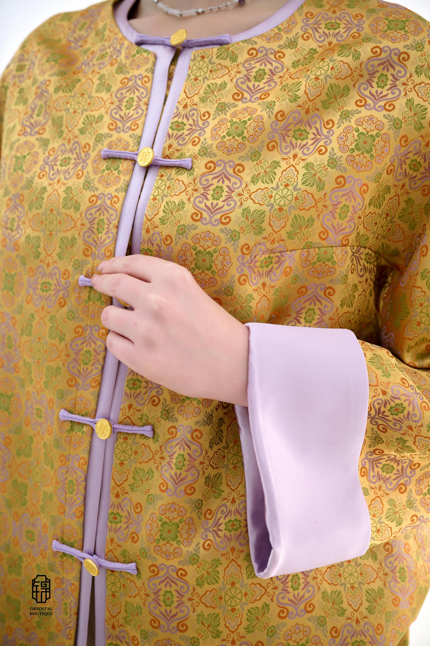 Golden Lilac Brocade Jacket,The Golden Lilac Brocade Jacket features a rich golden yellow base adorned with intricate floral patterns, embodying the timeless elegance of traditional Eastern fashion. The lilac accents on the collar, cuffs, and frog buttons
