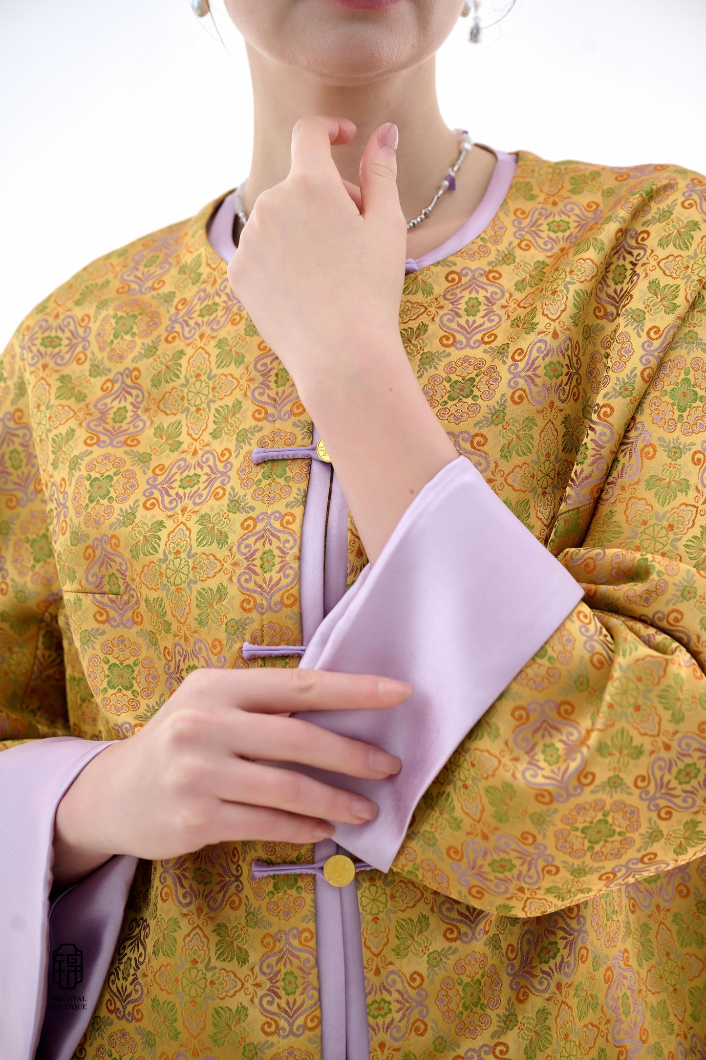 Golden Lilac Brocade Jacket,The Golden Lilac Brocade Jacket features a rich golden yellow base adorned with intricate floral patterns, embodying the timeless elegance of traditional Eastern fashion. The lilac accents on the collar, cuffs, and frog buttons