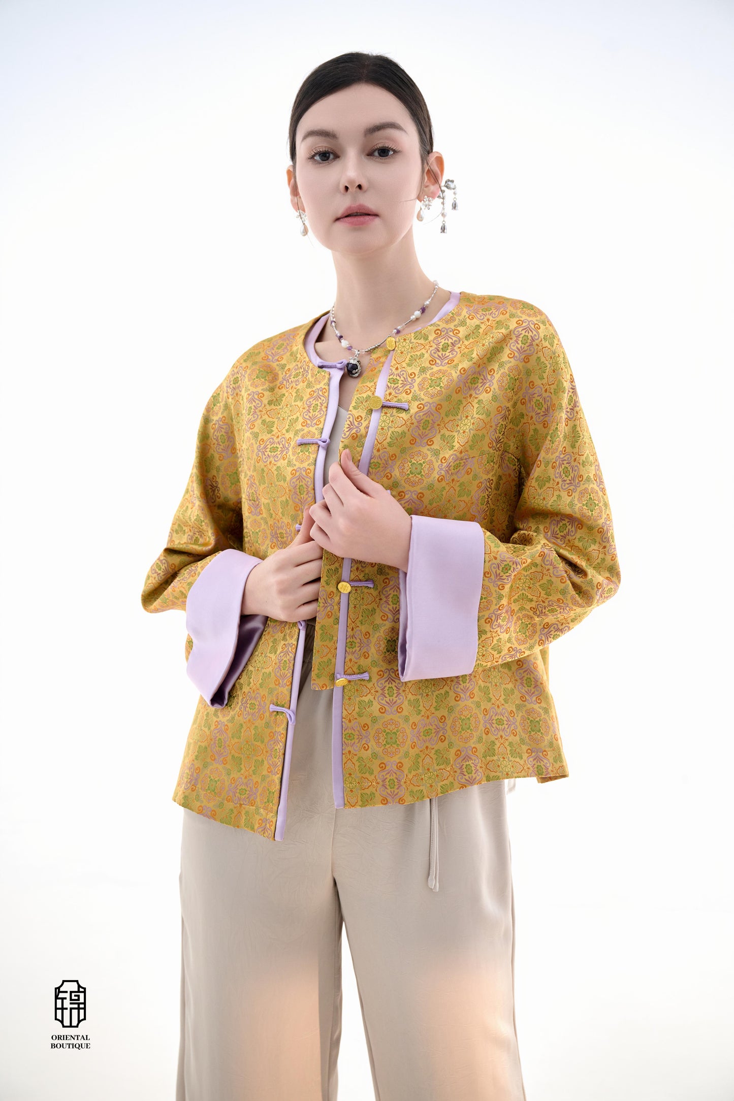 Golden Lilac Brocade Jacket,The Golden Lilac Brocade Jacket features a rich golden yellow base adorned with intricate floral patterns, embodying the timeless elegance of traditional Eastern fashion. The lilac accents on the collar, cuffs, and frog buttons