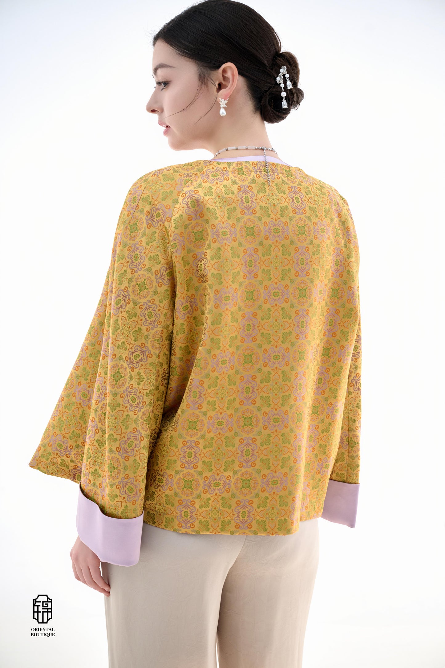 Golden Lilac Brocade Jacket,The Golden Lilac Brocade Jacket features a rich golden yellow base adorned with intricate floral patterns, embodying the timeless elegance of traditional Eastern fashion. The lilac accents on the collar, cuffs, and frog buttons