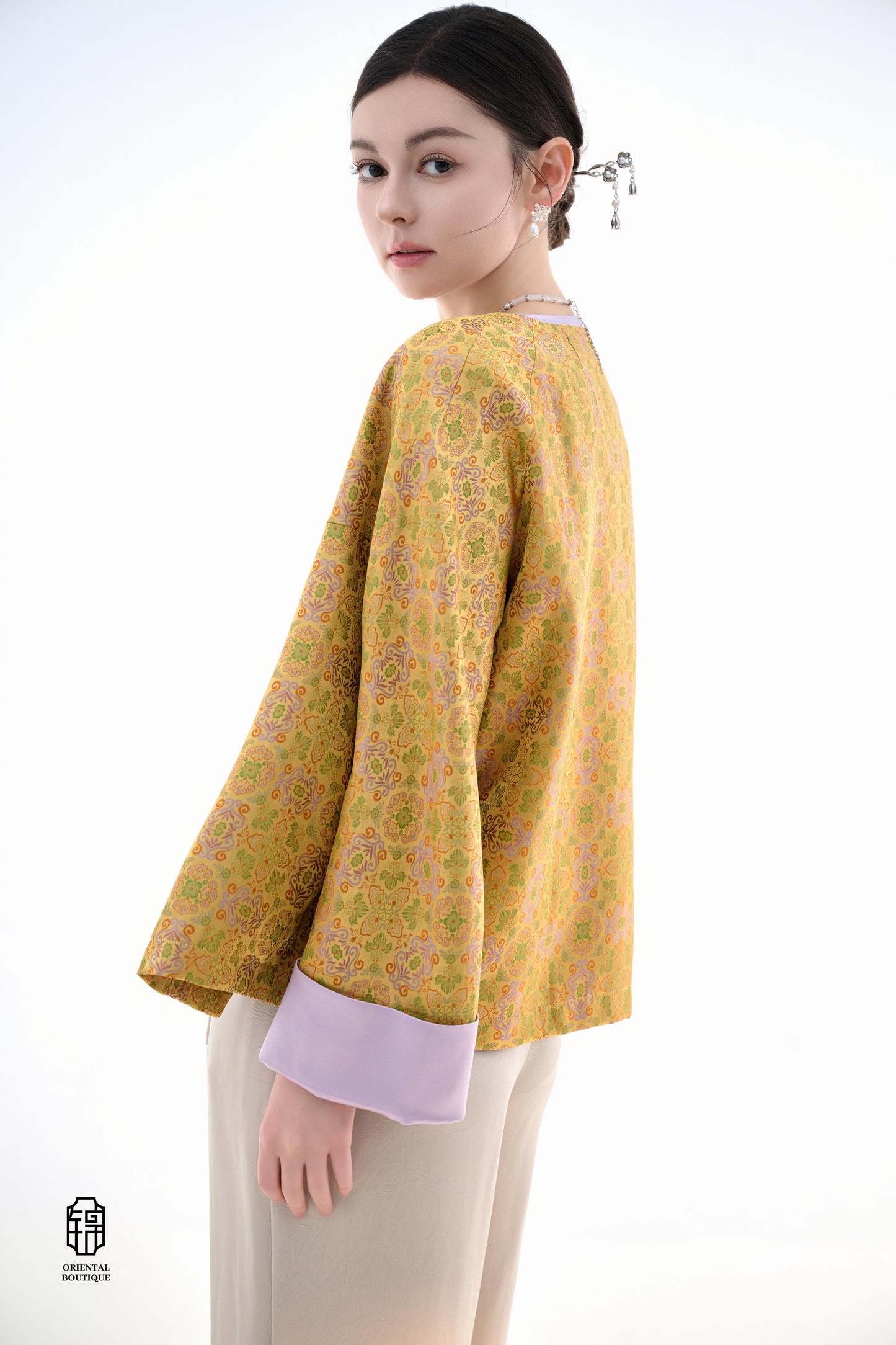 Golden Lilac Brocade Jacket,The Golden Lilac Brocade Jacket features a rich golden yellow base adorned with intricate floral patterns, embodying the timeless elegance of traditional Eastern fashion. The lilac accents on the collar, cuffs, and frog buttons