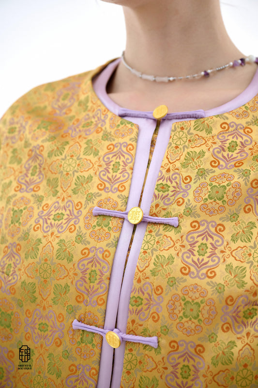 Golden Lilac Brocade Jacket,The Golden Lilac Brocade Jacket features a rich golden yellow base adorned with intricate floral patterns, embodying the timeless elegance of traditional Eastern fashion. The lilac accents on the collar, cuffs, and frog buttons