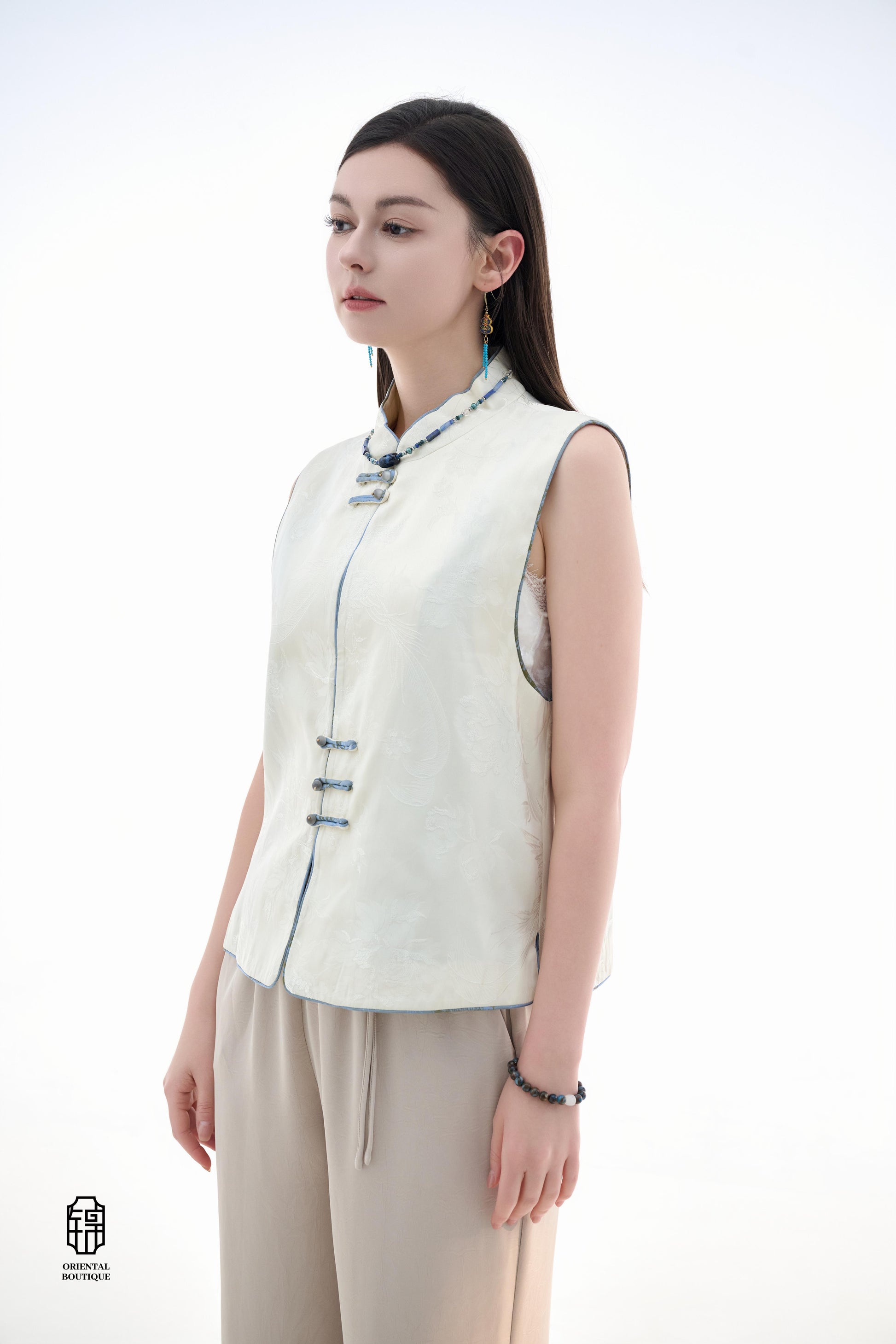 Cloud Brocade Mandarin Collar Sleeveless Vest,The Cloud Brocade Mandarin Collar Sleeveless Vest features a light brocade fabric, offering a simple and elegant look. The mandarin collar and traditional knotted buttons reflect the essence of classic Chinese