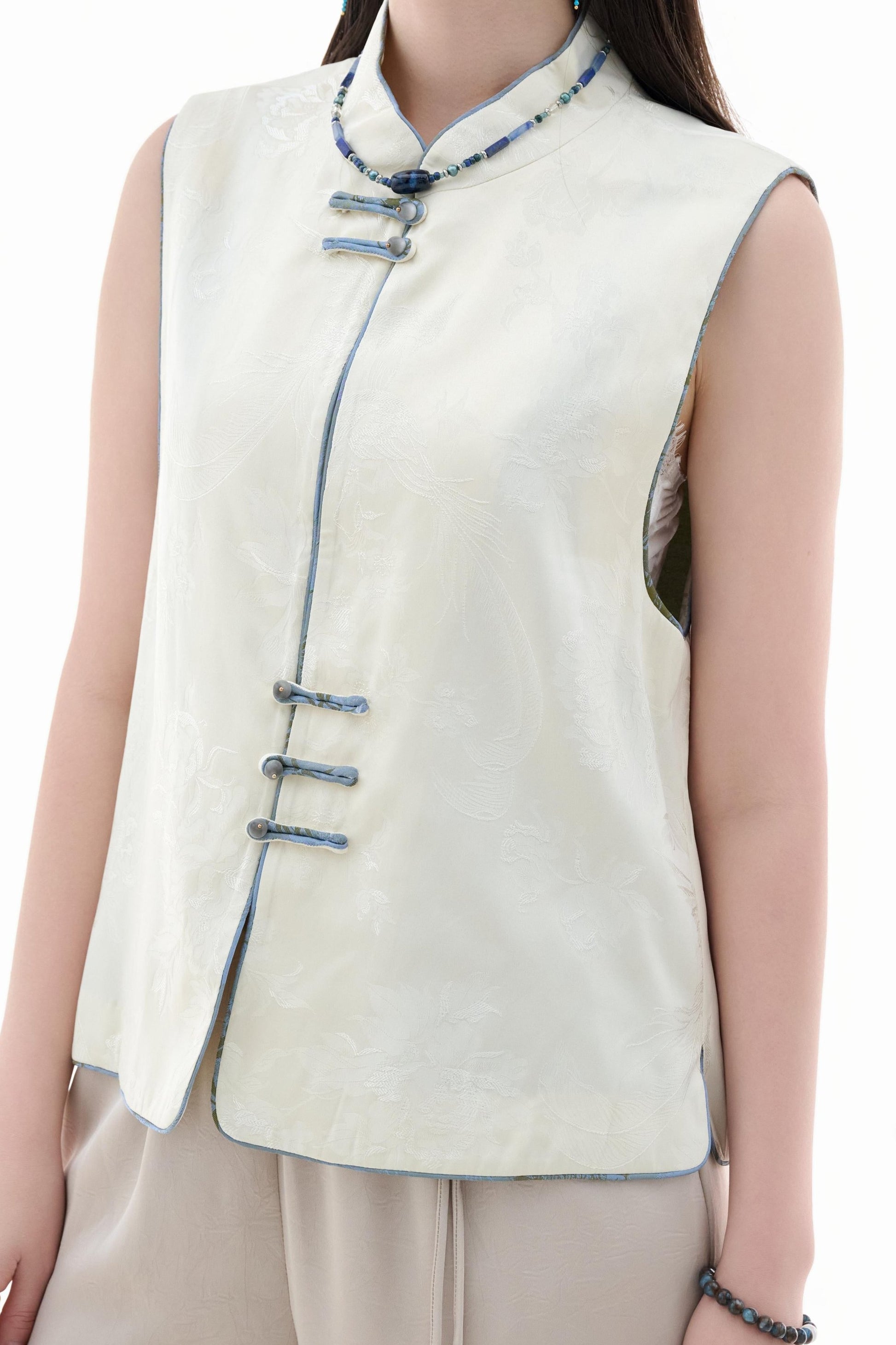 Cloud Brocade Mandarin Collar Sleeveless Vest,The Cloud Brocade Mandarin Collar Sleeveless Vest features a light brocade fabric, offering a simple and elegant look. The mandarin collar and traditional knotted buttons reflect the essence of classic Chinese