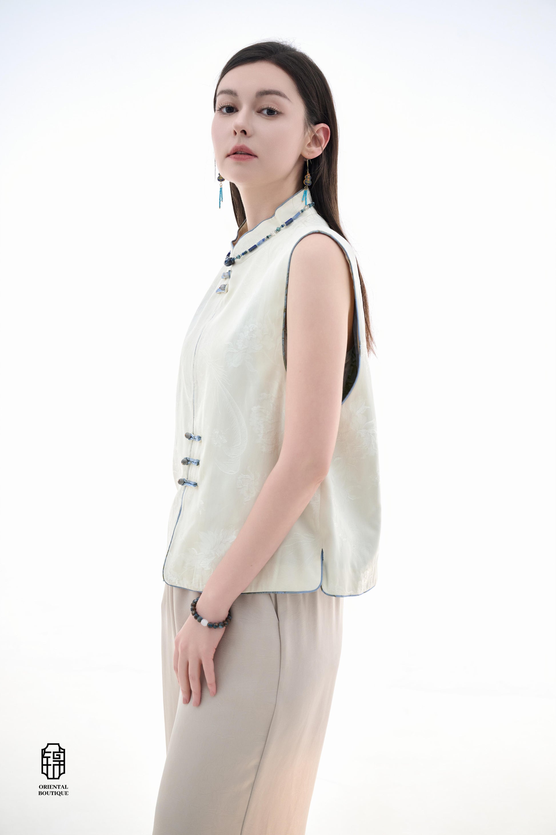 Cloud Brocade Mandarin Collar Sleeveless Vest,The Cloud Brocade Mandarin Collar Sleeveless Vest features a light brocade fabric, offering a simple and elegant look. The mandarin collar and traditional knotted buttons reflect the essence of classic Chinese