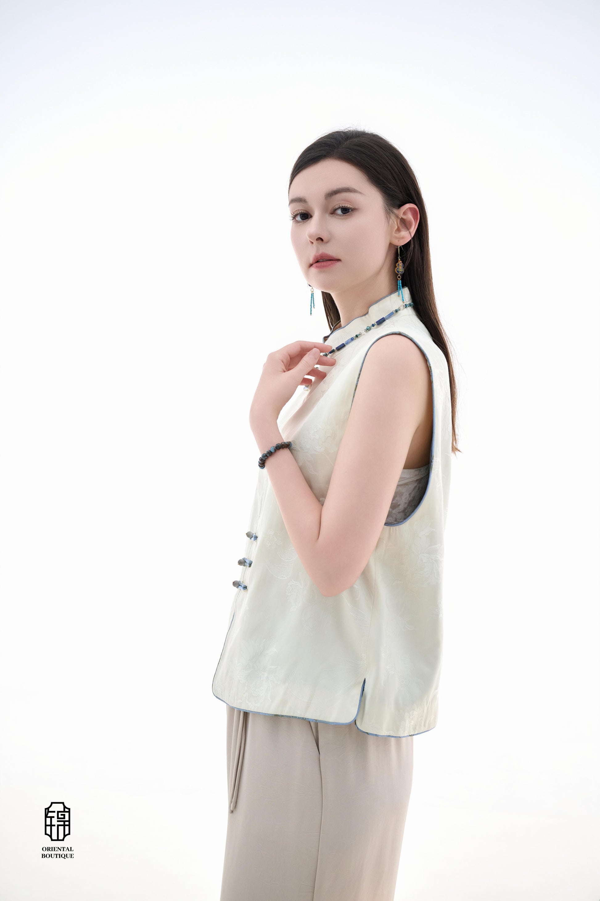 Cloud Brocade Mandarin Collar Sleeveless Vest,The Cloud Brocade Mandarin Collar Sleeveless Vest features a light brocade fabric, offering a simple and elegant look. The mandarin collar and traditional knotted buttons reflect the essence of classic Chinese