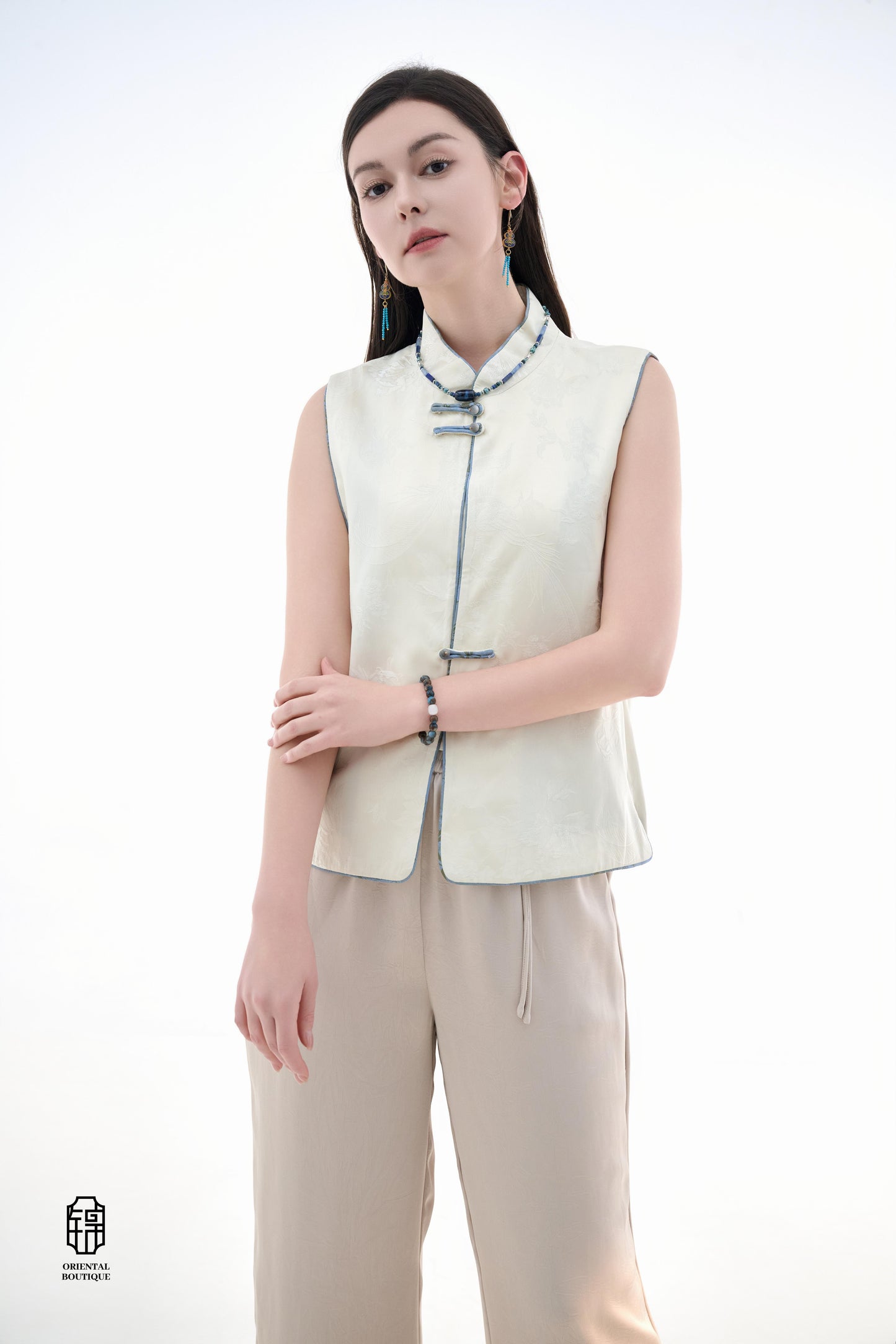 Cloud Brocade Mandarin Collar Sleeveless Vest,The Cloud Brocade Mandarin Collar Sleeveless Vest features a light brocade fabric, offering a simple and elegant look. The mandarin collar and traditional knotted buttons reflect the essence of classic Chinese