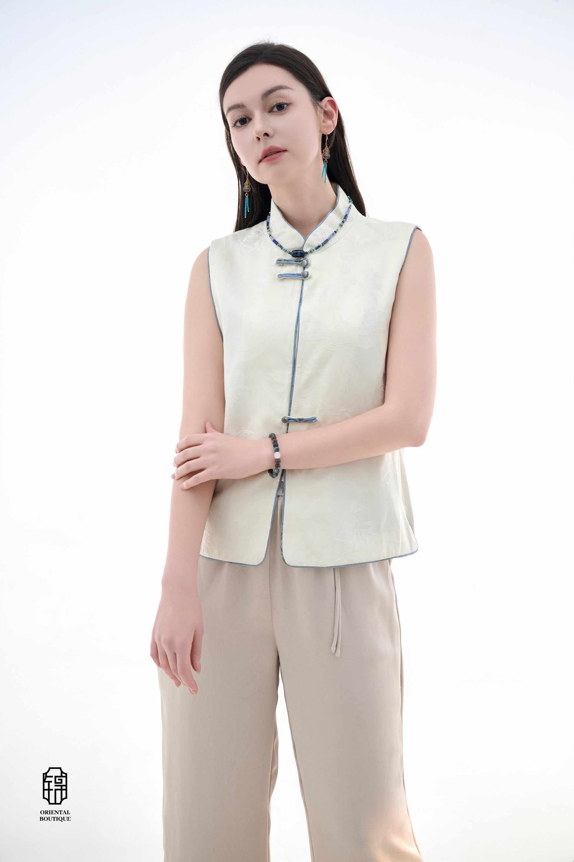 Cloud Brocade Mandarin Collar Sleeveless Vest,The Cloud Brocade Mandarin Collar Sleeveless Vest features a light brocade fabric, offering a simple and elegant look. The mandarin collar and traditional knotted buttons reflect the essence of classic Chinese